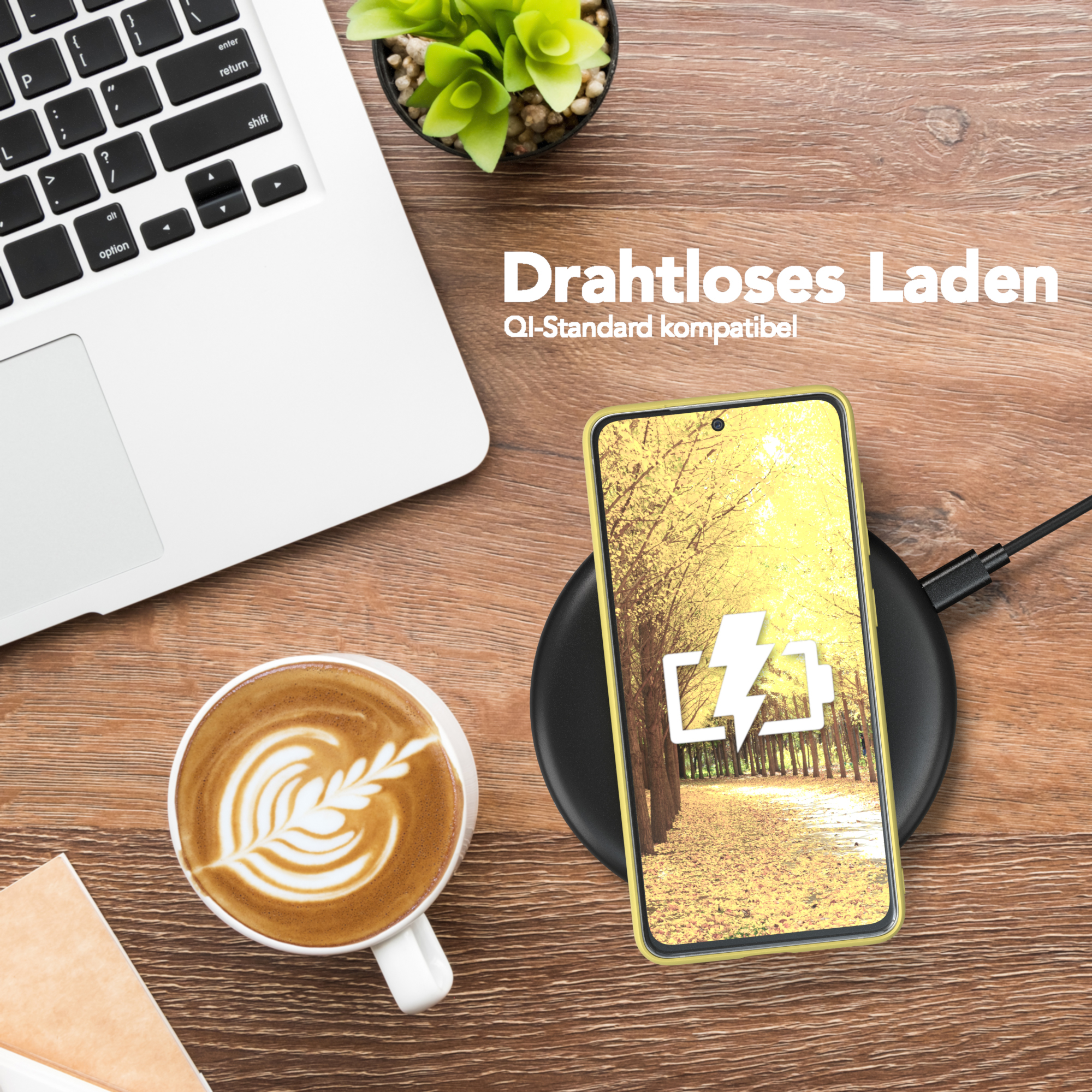 Telefon mit gelber Hülle, das kabellos geladen wird. Laptop und Kaffeetasse daneben.