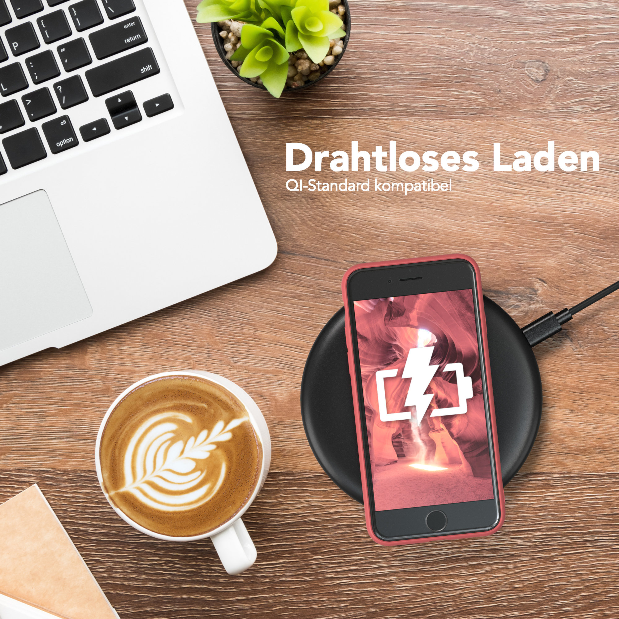 Ein Telefon wird drahtlos auf einem Pad mit Kaffee und Laptop aufgeladen.