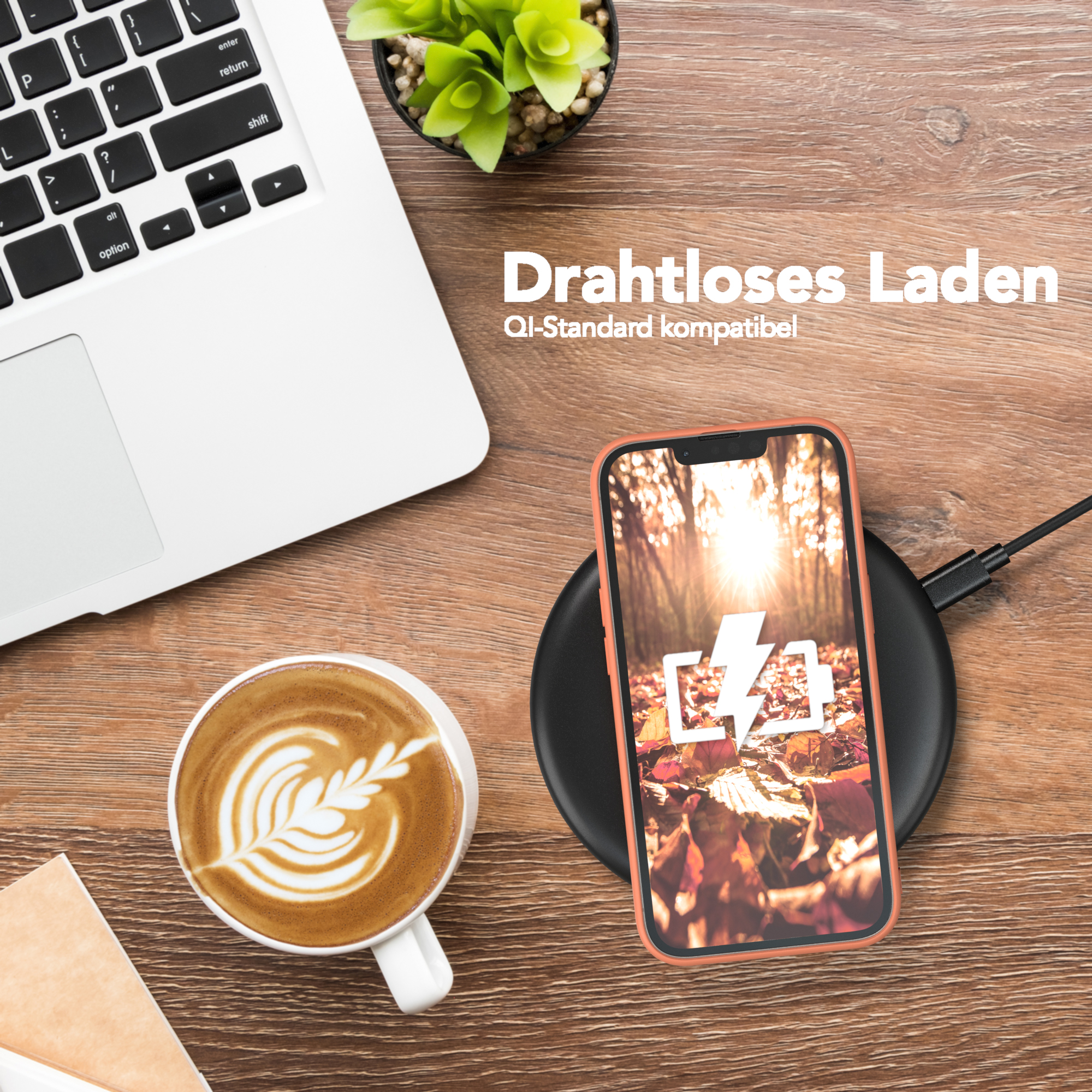 Telefon wird kabellos auf einem Pad geladen. Eine Tasse Kaffee und ein Laptop auf einem Holztisch.