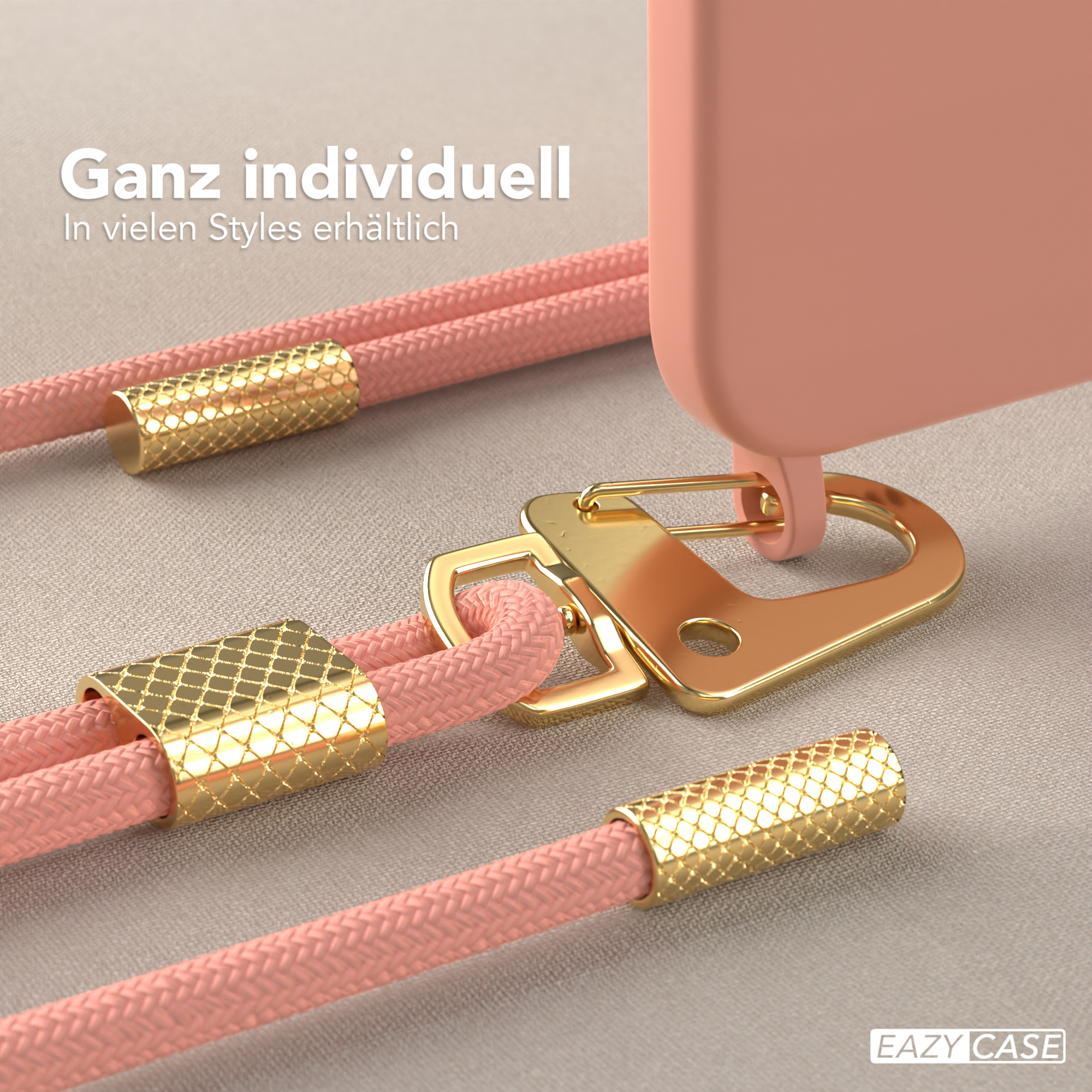Nahaufnahme: Rosa Handyschlaufe mit goldenen Akzenten. Hülle mit goldenem Ring. Strukturierter Hintergrund.