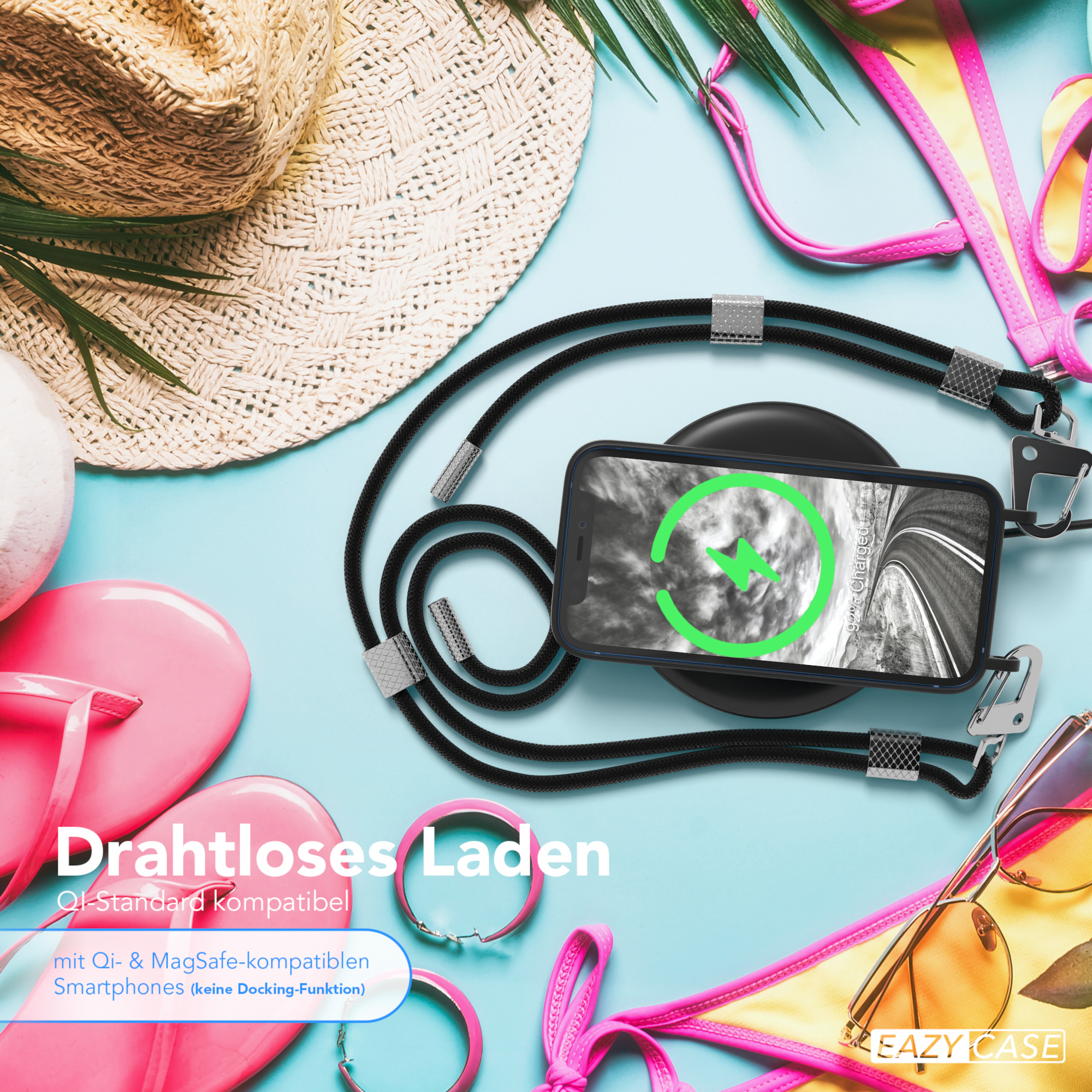 Telefon drahtlos auf einem Strandtuch laden, umgeben von Zubehör.