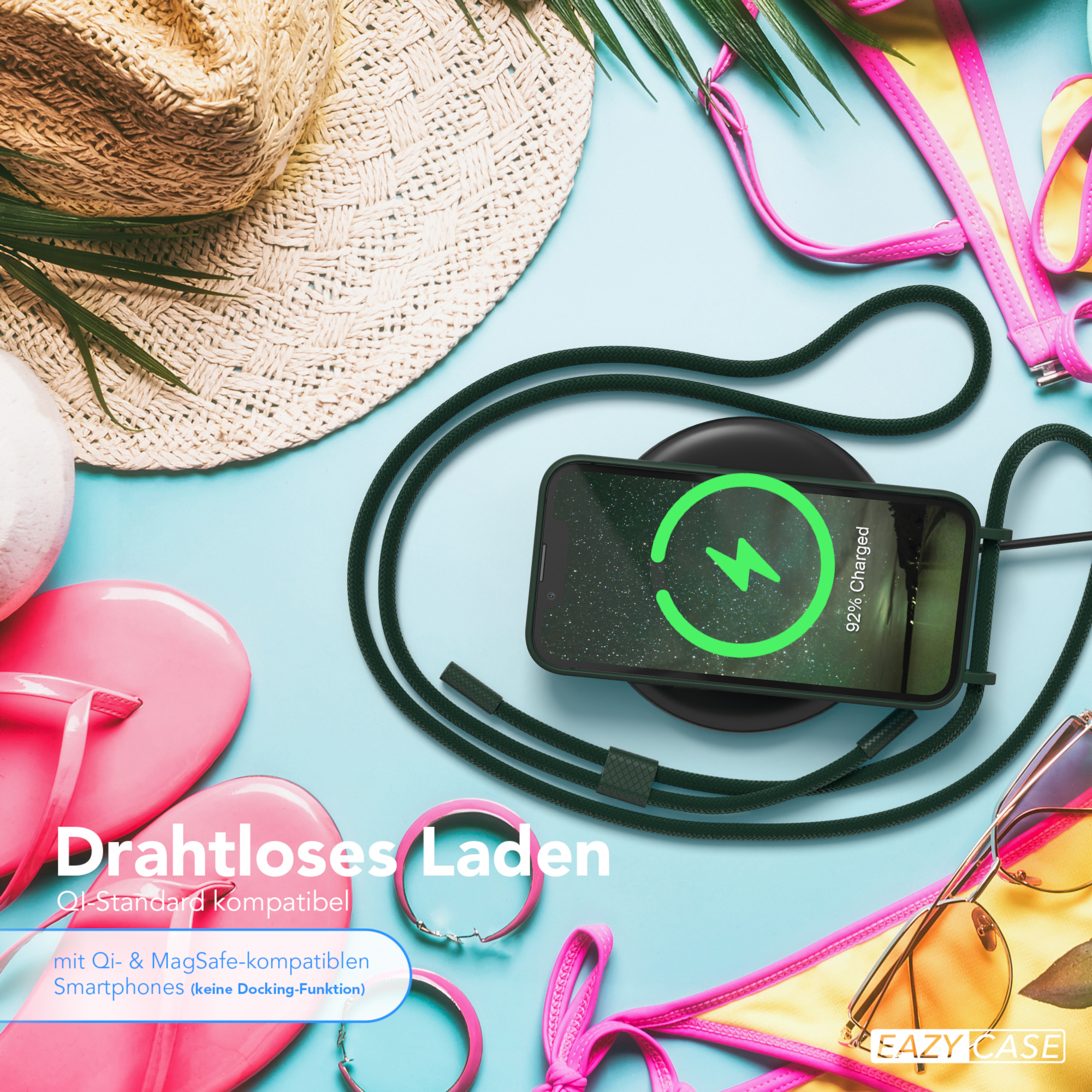 Ein Telefon, das drahtlos auf einem Pad geladen wird, mit Strandartikeln im Hintergrund.