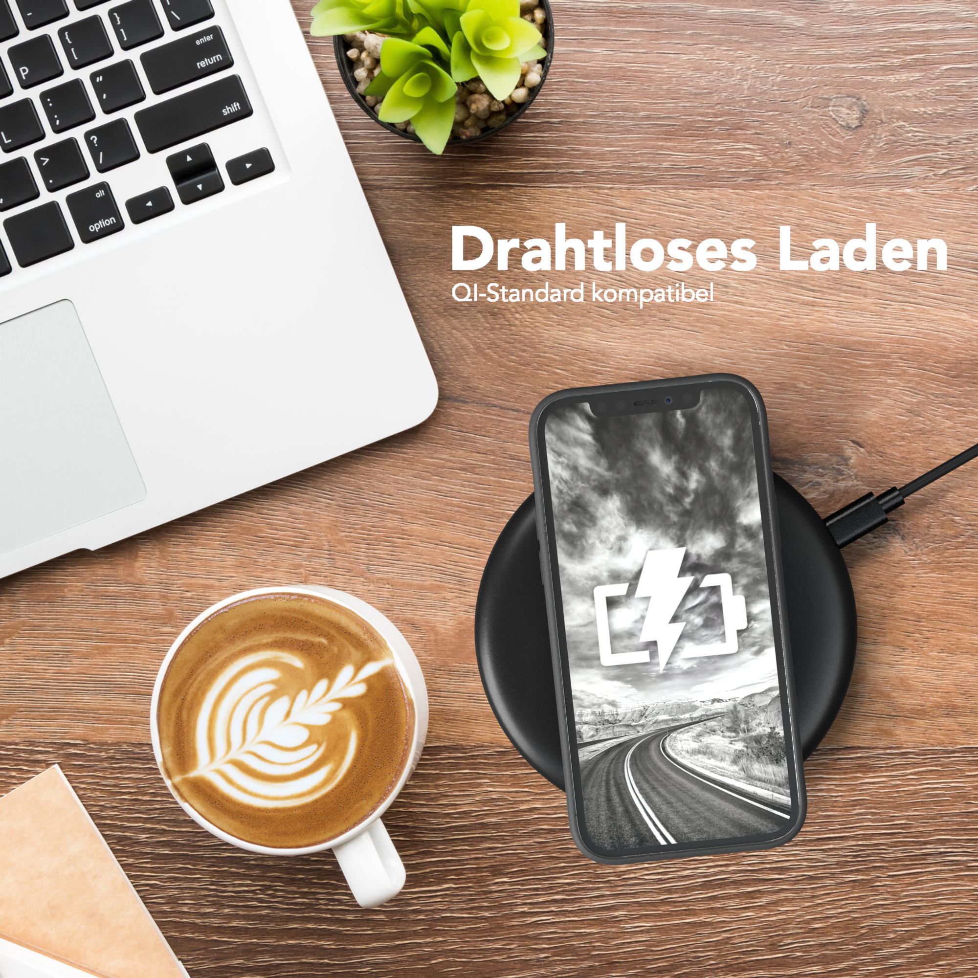 Ein Telefon auf einem kabellosen Ladegerät mit einer Kaffeetasse und einem Laptop.