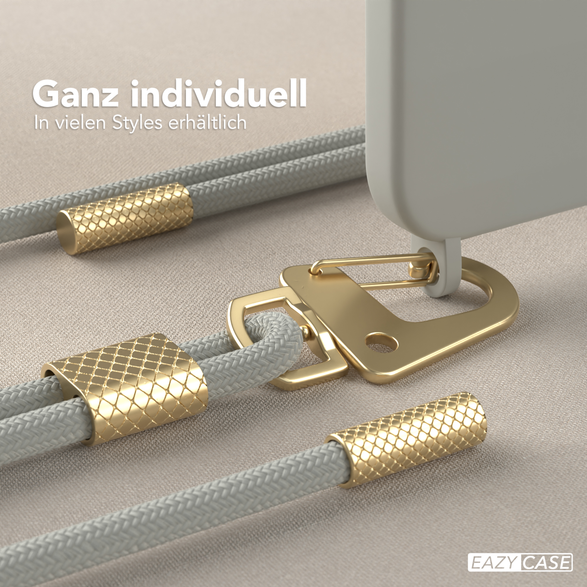 Nahaufnahme eines Telefon-Lanyards mit goldfarbenem Metall und grauem Seil. Das Lanyard liegt.