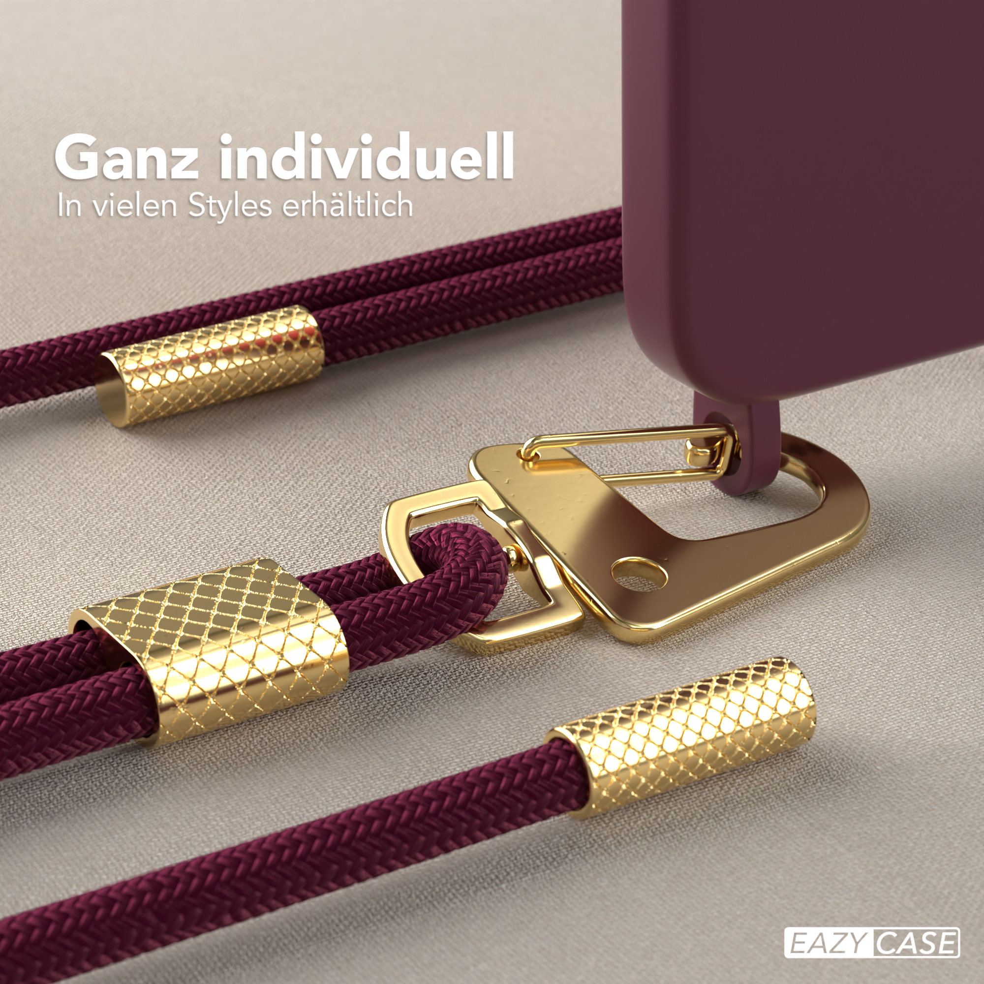 Nahaufnahme einer Handyhülle mit goldenen Details. Die Hülle ist lila mit goldenen Akzenten. Metallverschluss sichtbar.