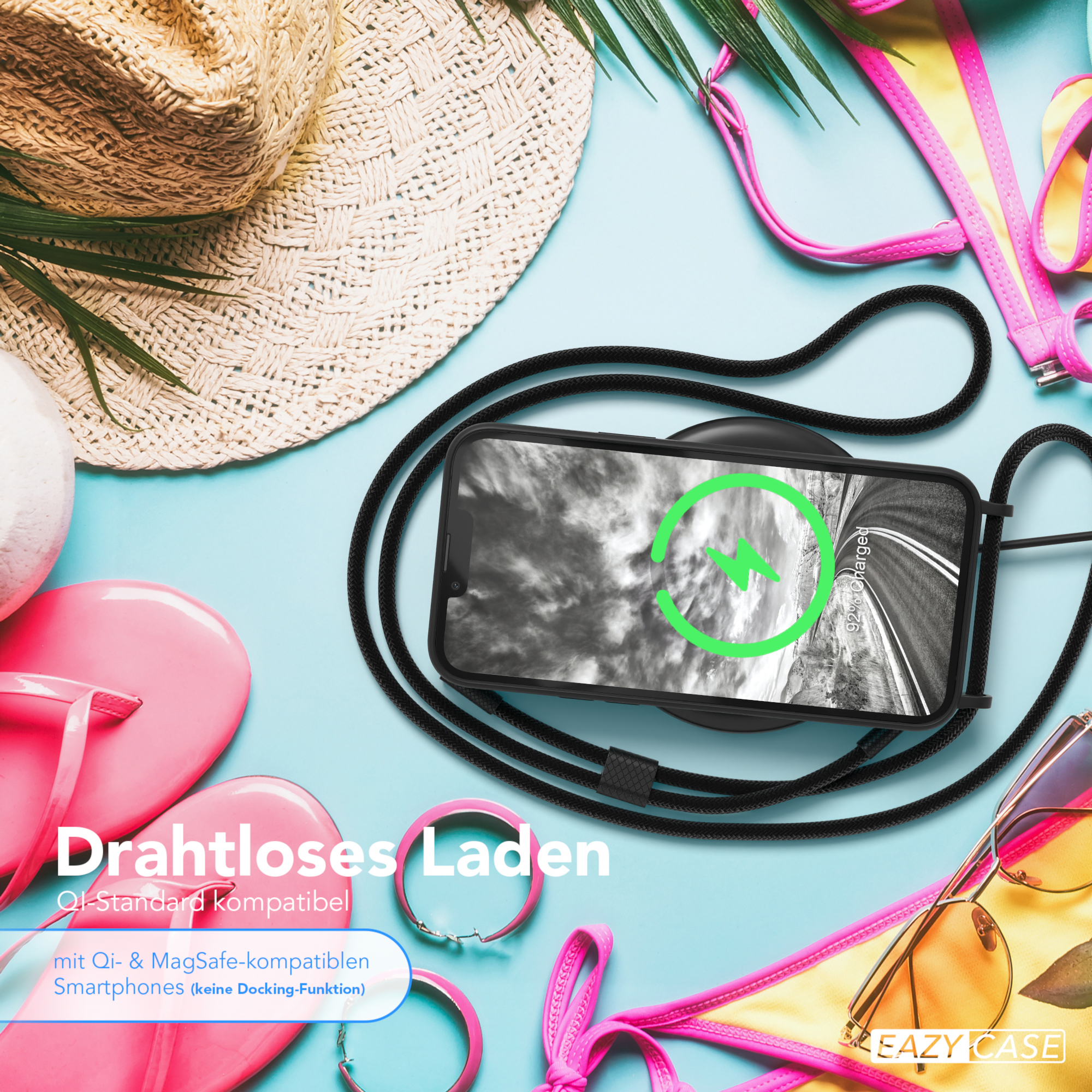 Telefon lädt auf einem kabellosen Ladegerät, neben Accessoires wie Sonnenbrille und Hut.