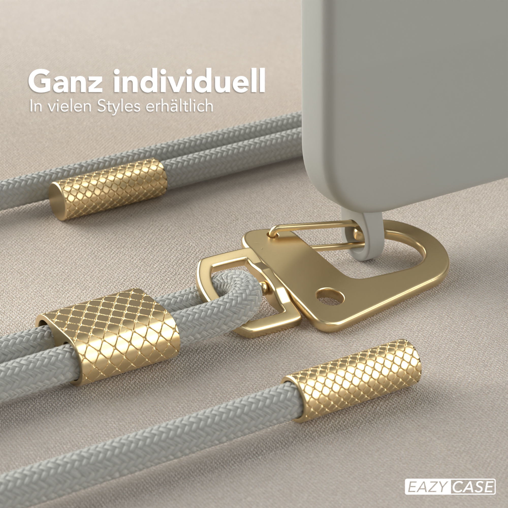 Nahaufnahme eines Handy-Lanyards mit goldenen Akzenten und einem grauen Telefon. Der Hintergrund ist neutral.