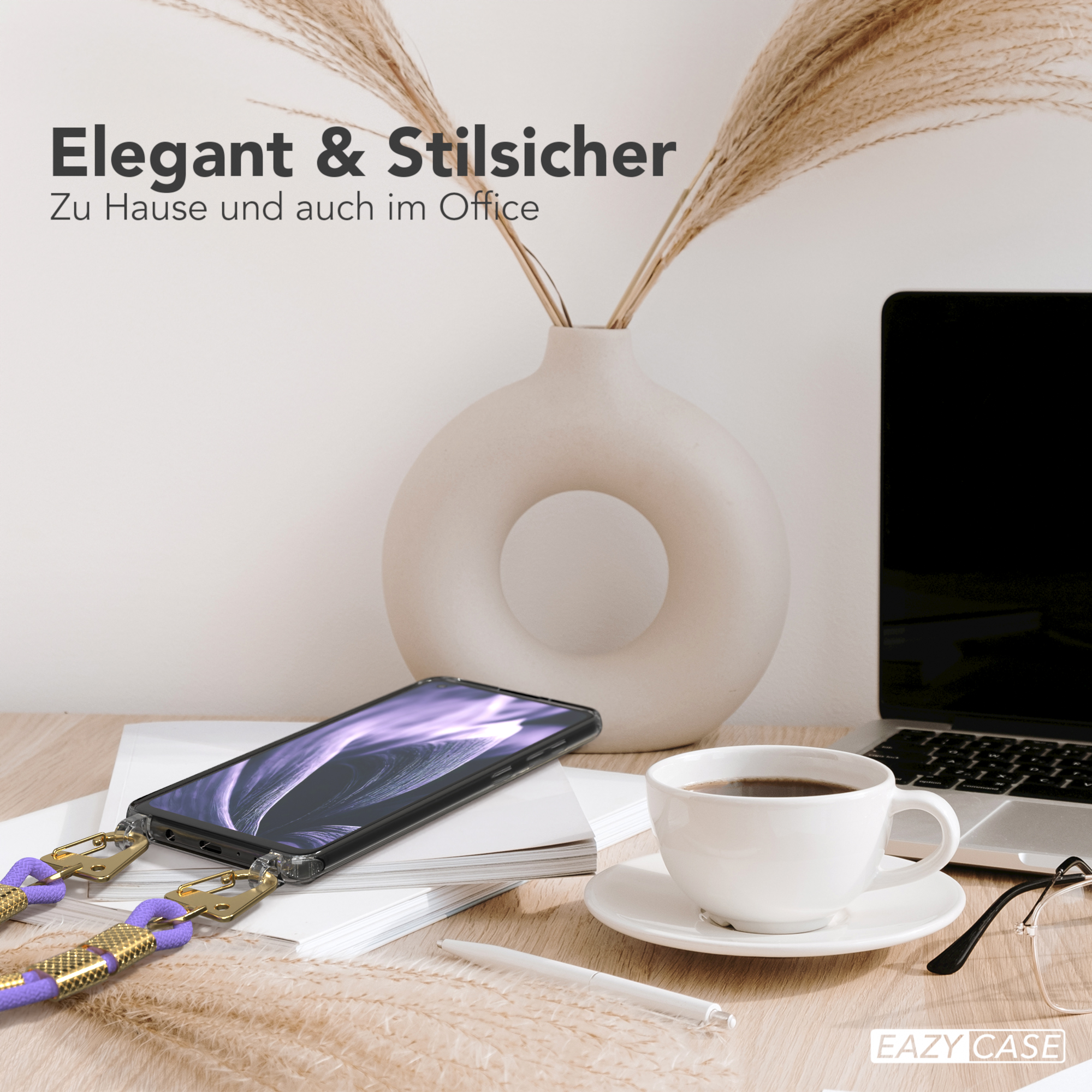 Ein Telefon auf einem Schreibtisch mit einer Kaffeetasse, einem Laptop und einer Vase mit Trockenblumen.