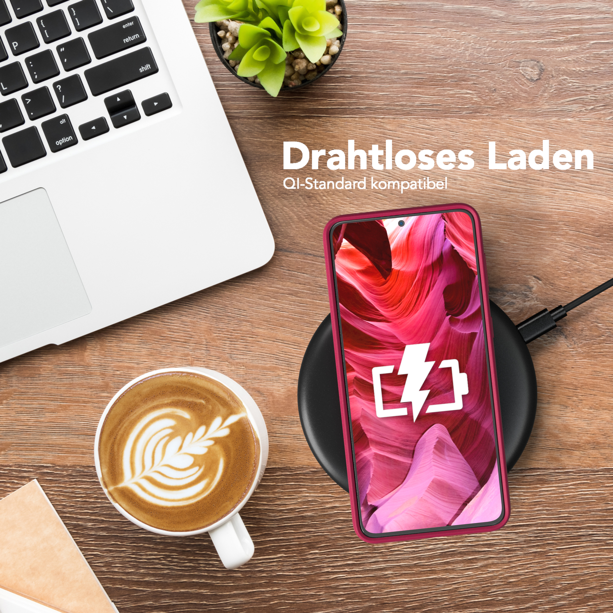Telefon auf kabellosem Ladegerät. Laptop und Kaffeetasse auf Holztisch. Text: 'Drahtloses Laden'.