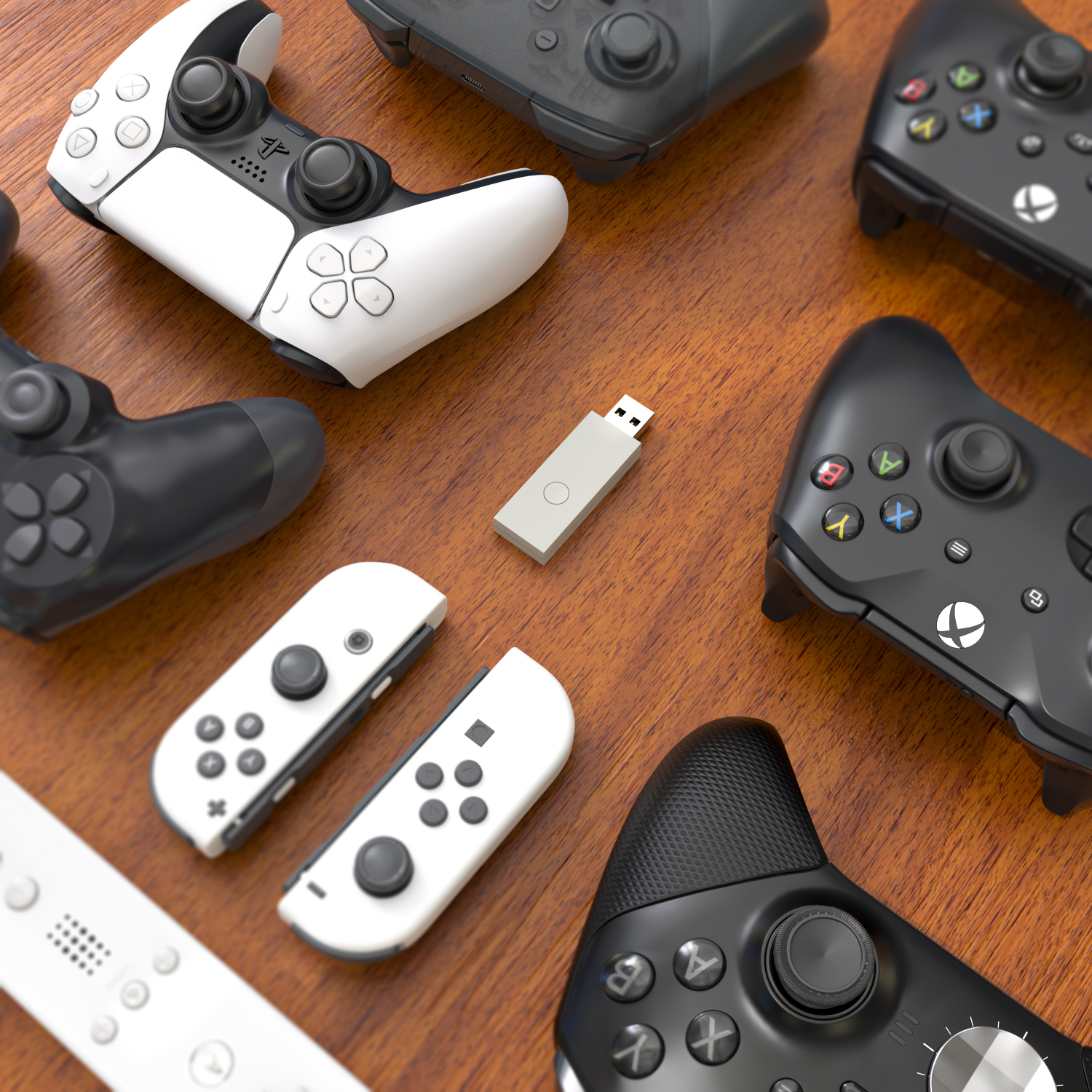 Una vista cenital con varios mandos de videojuegos y una unidad USB sobre una superficie de madera.