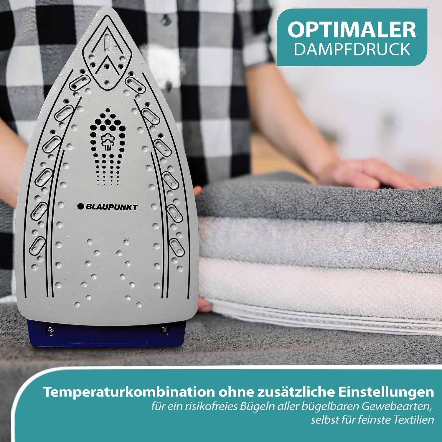 Bügelbrett mit Bügeleisen und Handtüchern. Text: "optimaler Dampfdruck" und Anweisungen.