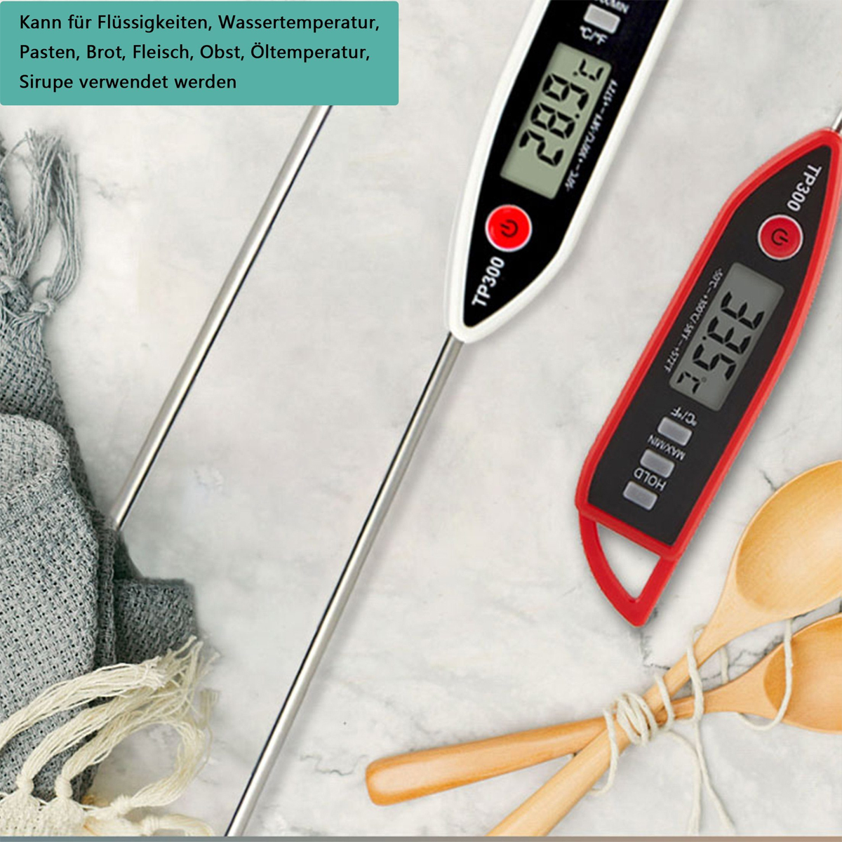 Zwei Thermometer mit Digitalanzeigen. Eines zeigt 28,9°C, das andere 33,5°C an. Holzlöffel befinden sich im Vordergrund.