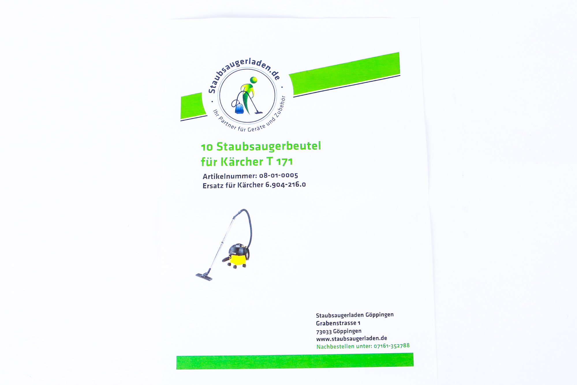 Papier mit Text und einem kleinen Staubsaugerbild auf weißem Hintergrund.