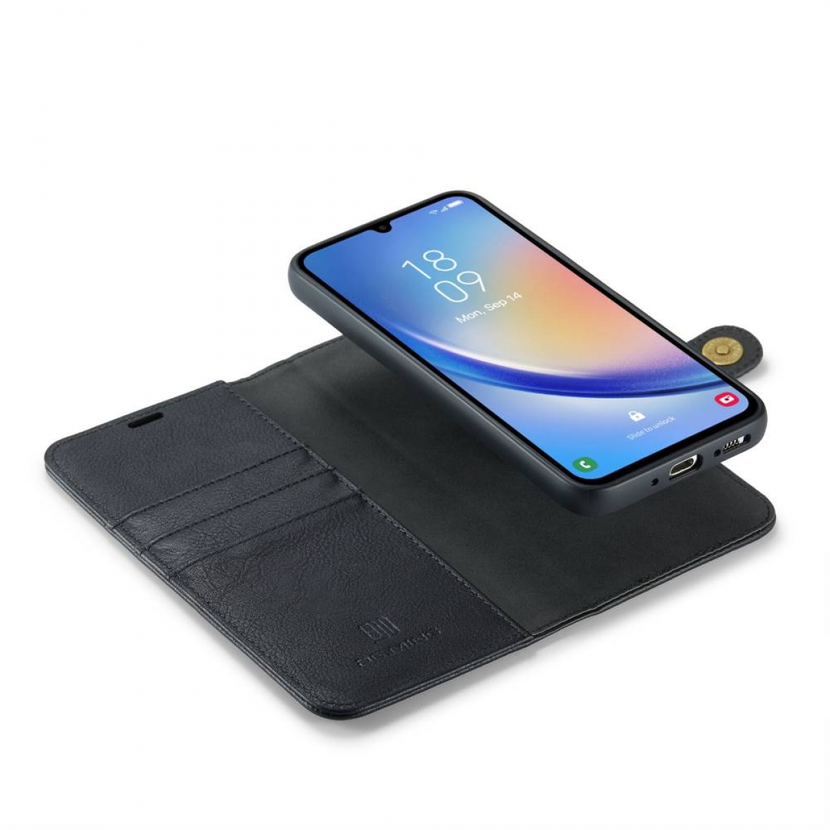 Schwarze Handyhülle mit Telefon darin, geöffnet auf weißer Oberfläche.