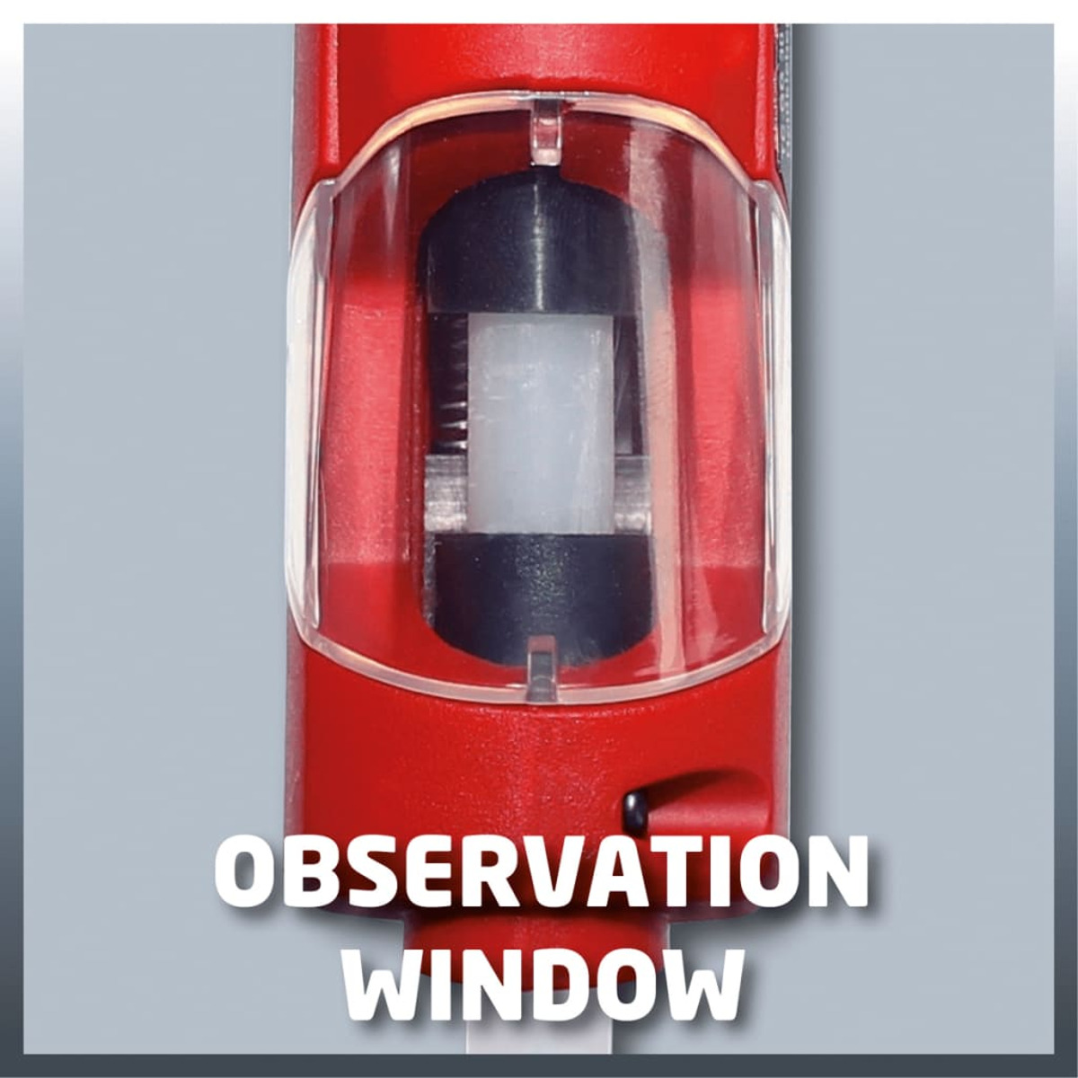 Czerwone urządzenie z oknem obserwacyjnym. Okno pokazuje czarno-biały komponent wewnętrzny.