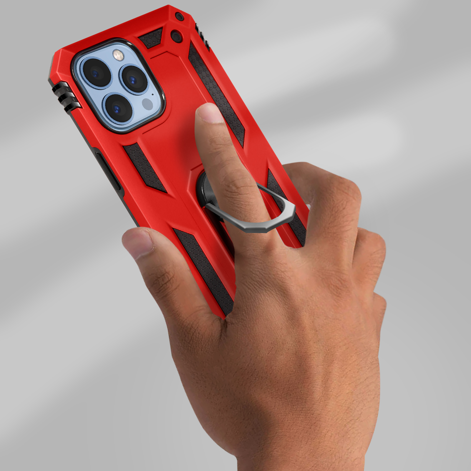 Rode telefoonhoes met ringhouder. Hand houdt de hoes vast. Grijze achtergrond.