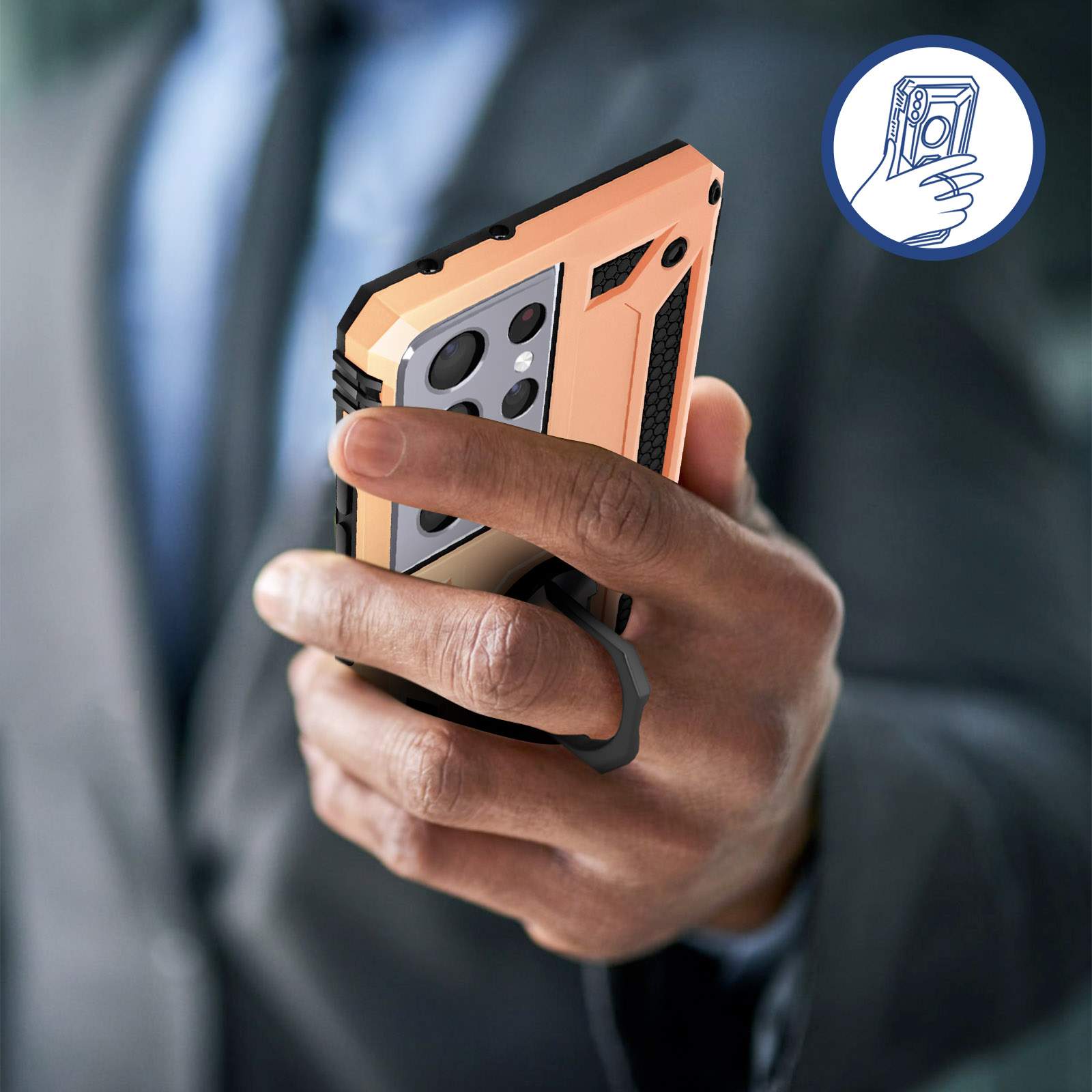 Eine Hand hält ein Telefon mit einem orangefarbenen Gehäuse. Ein Finger befindet sich im Ringhalter. Ein blaues Symbol befindet sich in der Ecke.
