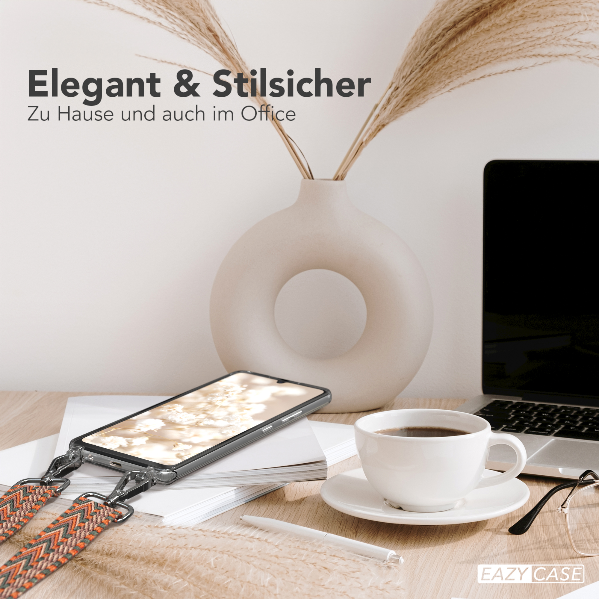 Ein Telefon mit Gurt auf einem Schreibtisch mit Kaffee, Brille und Stift. Der Text ist 'Elegant'.