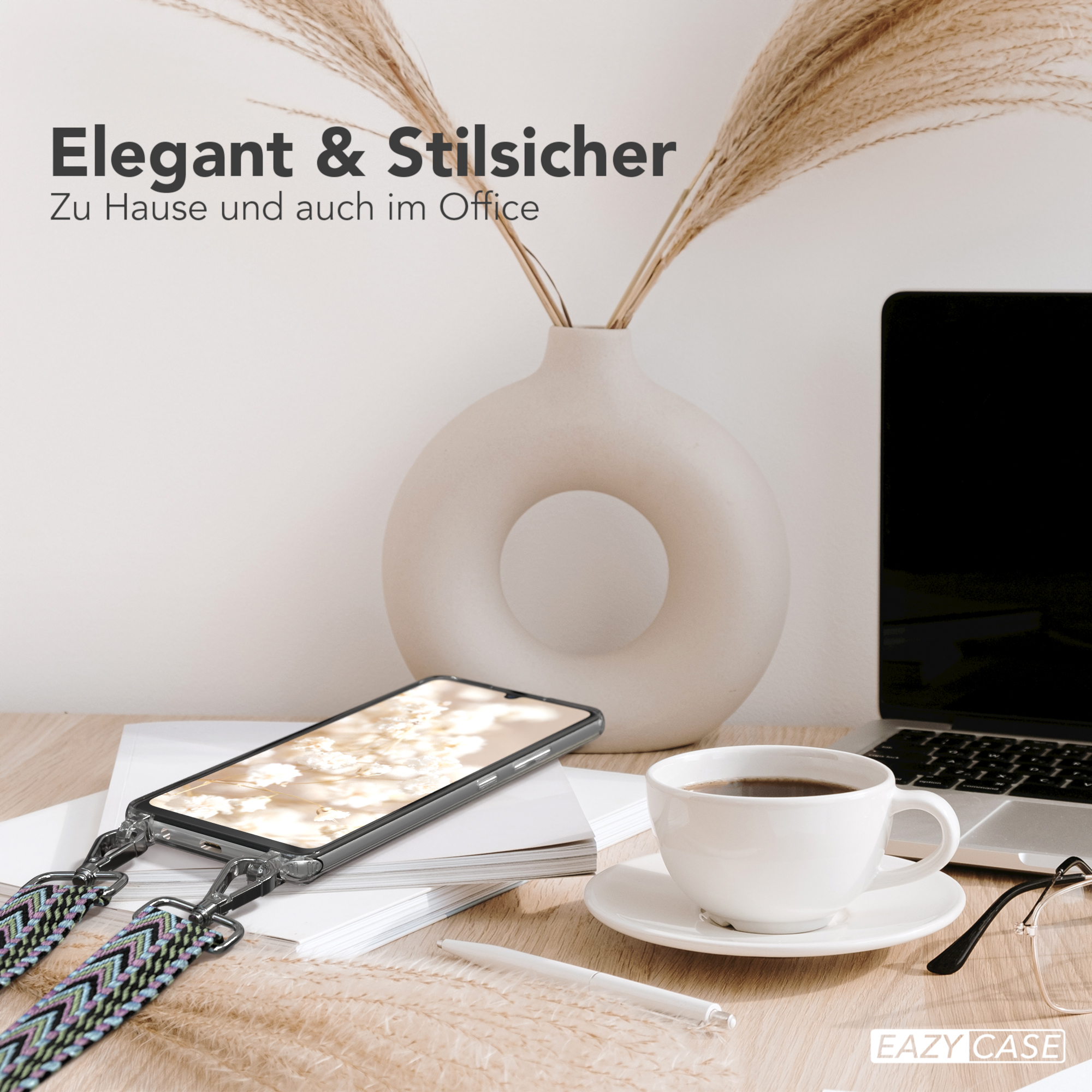 Ein Telefon auf einem Schreibtisch mit Kaffee, Laptop und Armband. Die Szene ist elegant.