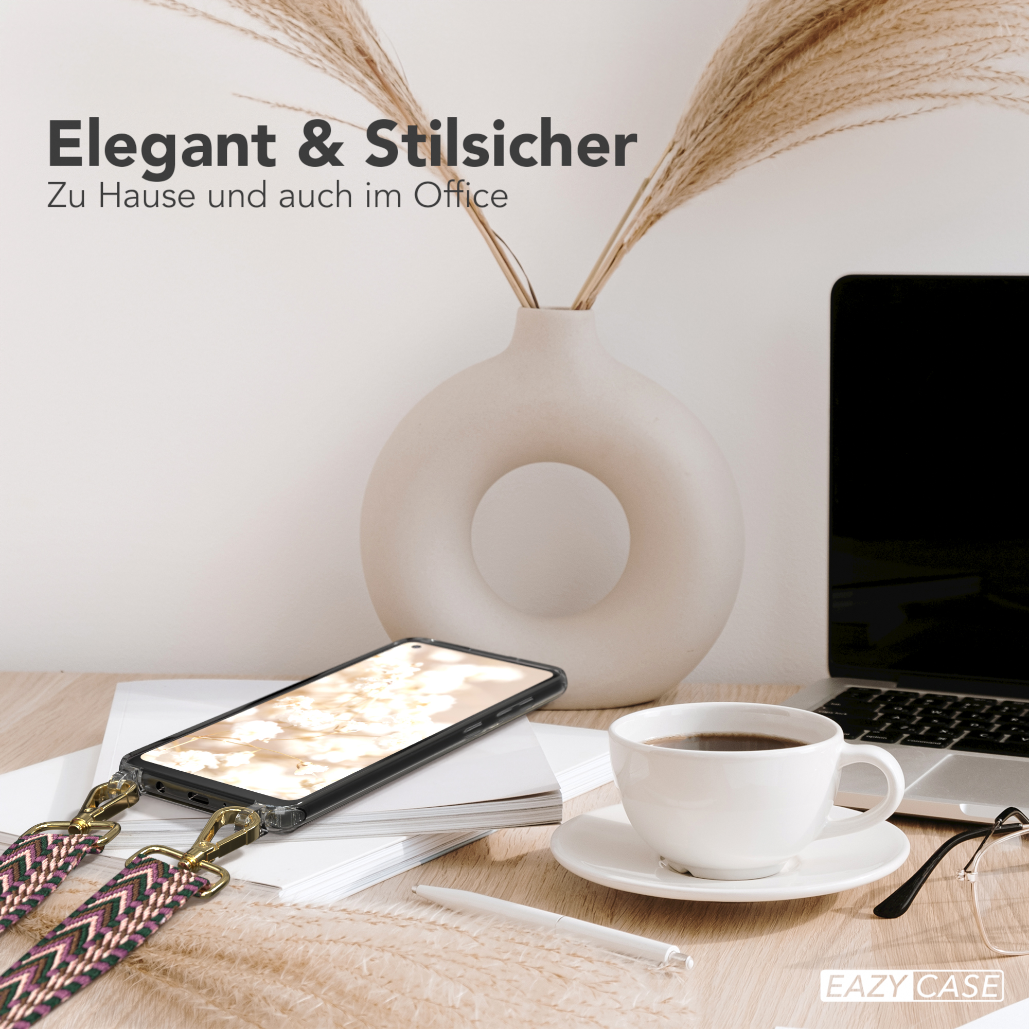 Ein Telefon auf einem Schreibtisch mit Kaffeetasse, Vase und Laptop, mit Telefonriemen.