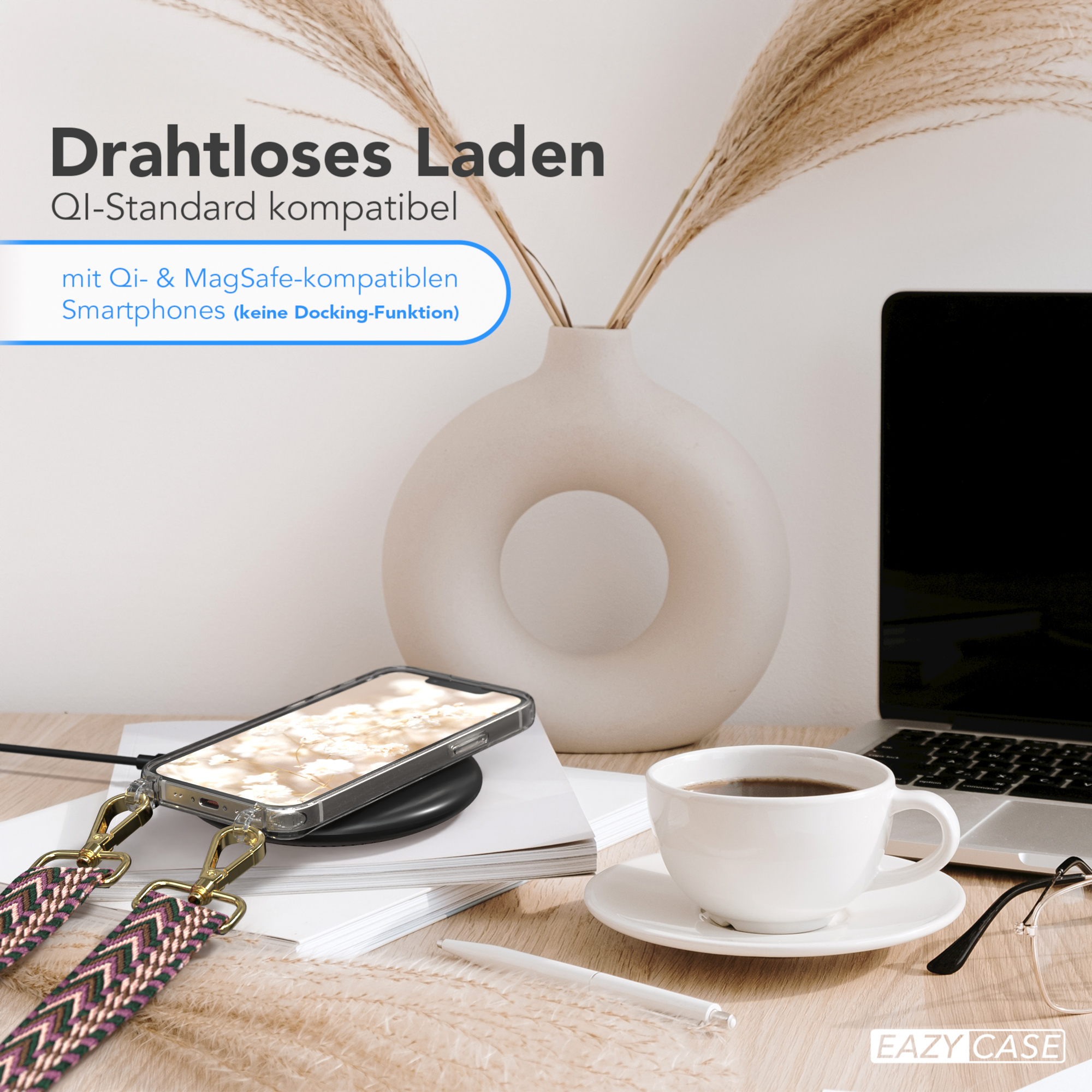 Ein Telefon wird kabellos auf einem Schreibtisch mit einer Kaffeetasse und Blumen geladen. Ein Stift liegt neben der Tasse.