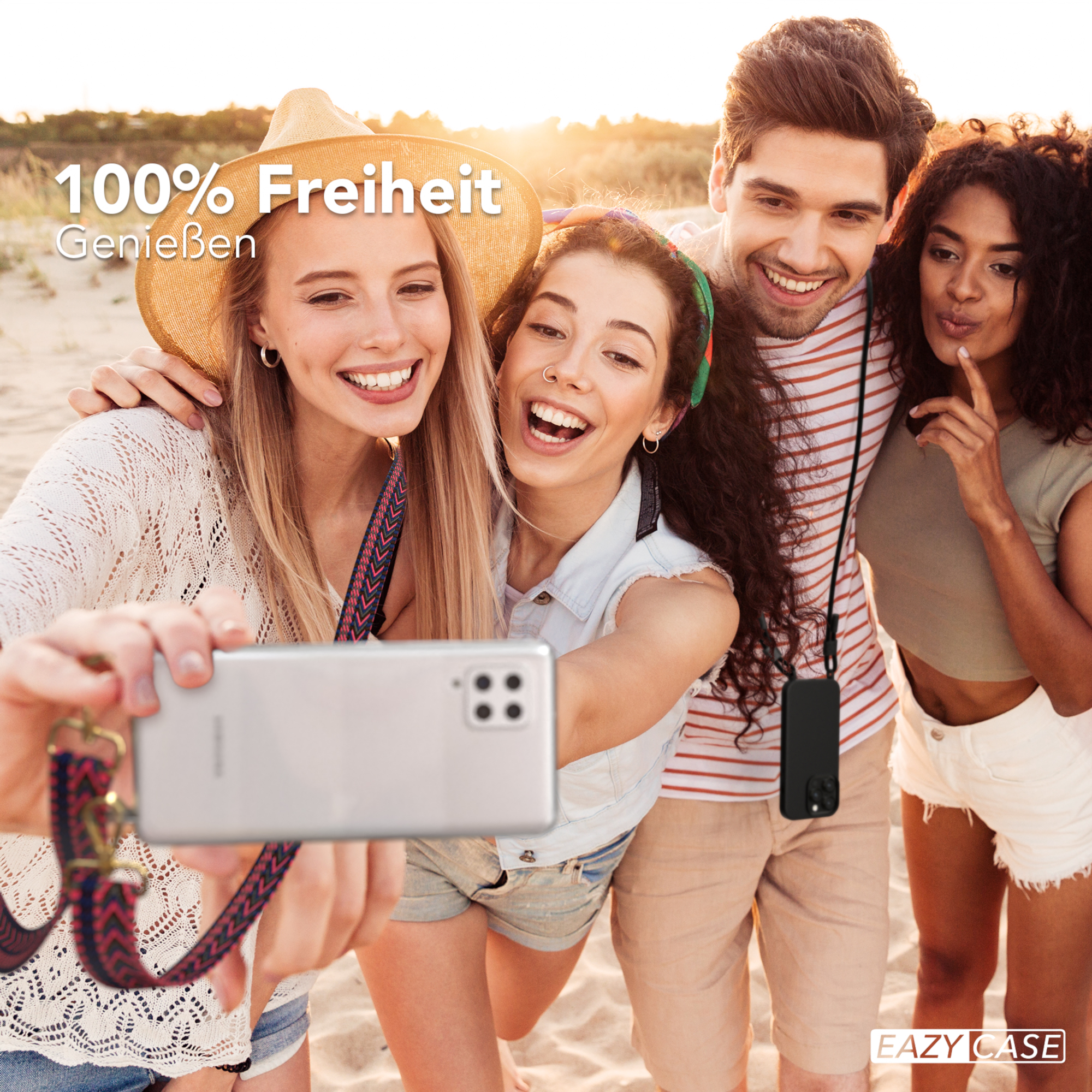 Vier Personen machen ein Selfie am Strand. Sie lächeln und sind glücklich.