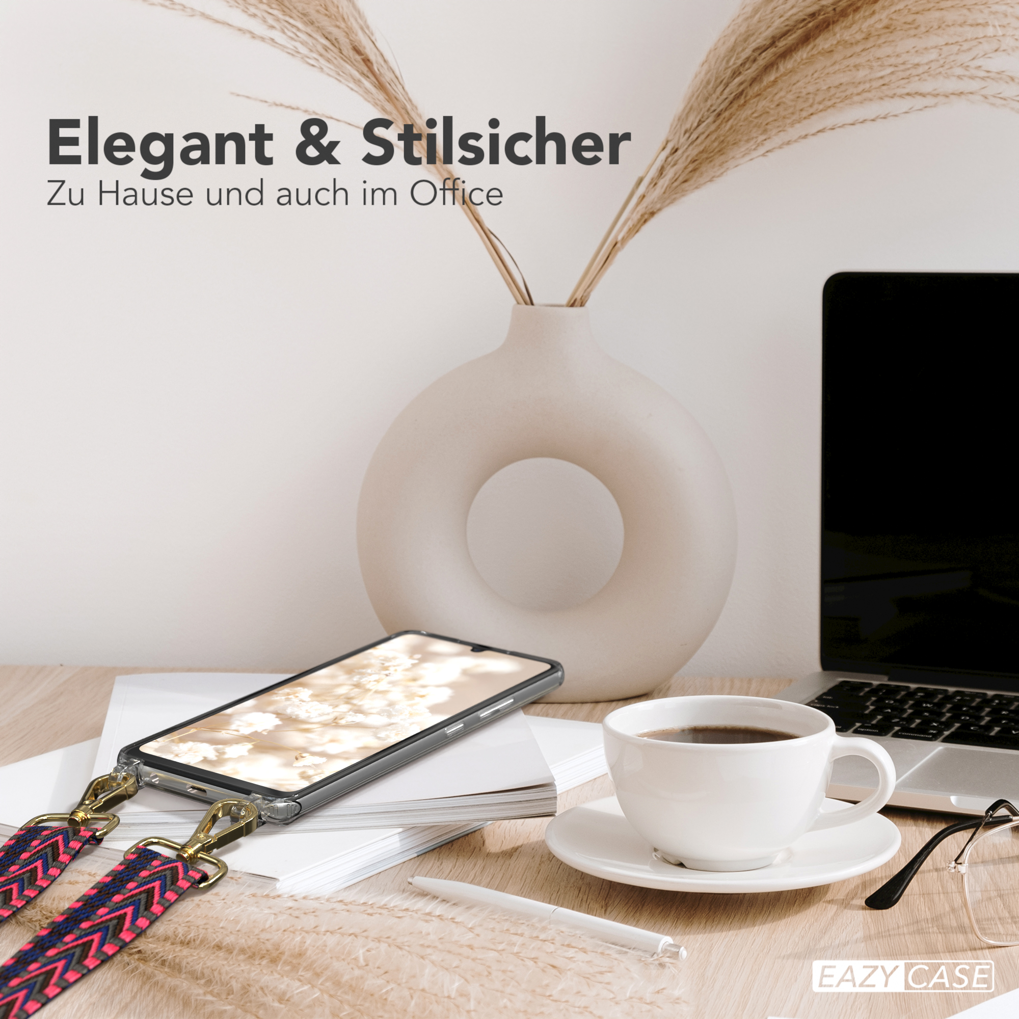 Telefon mit Riemen auf einem Schreibtisch. Kaffeetasse, Vase und Laptop im Hintergrund.