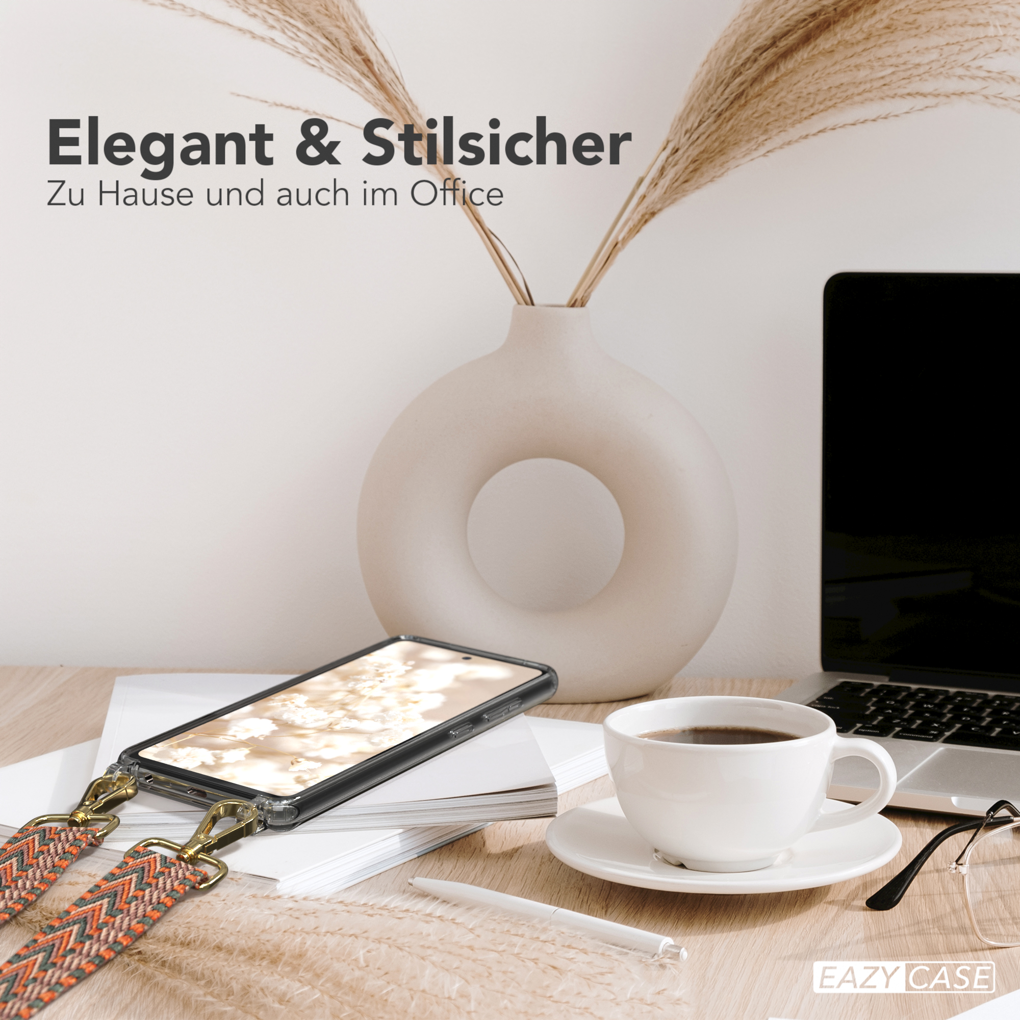 Telefon auf einem Schreibtisch, mit Kaffee, Stift und Brille. Telefon hat eine Schlaufe.