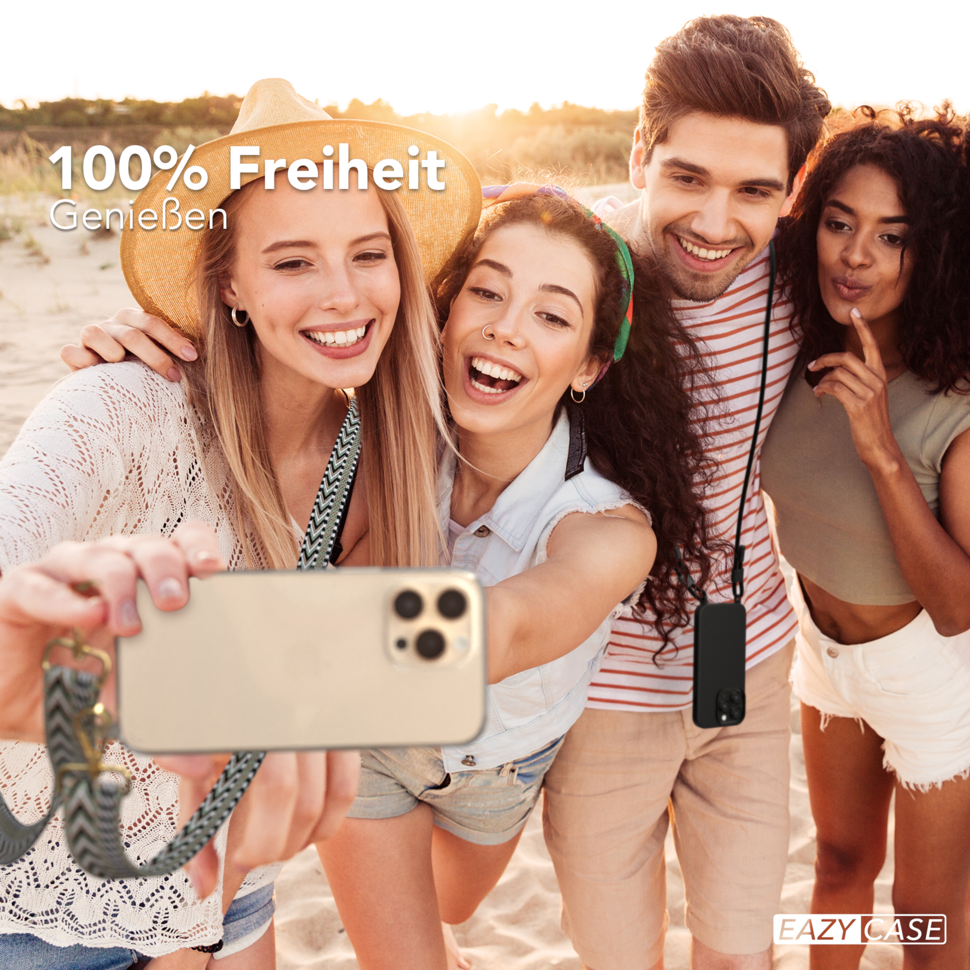 Vier Personen machen Selfie am Strand. Einer hält Telefon mit Hülle, andere lächeln. Sand und Meer im Hintergrund.