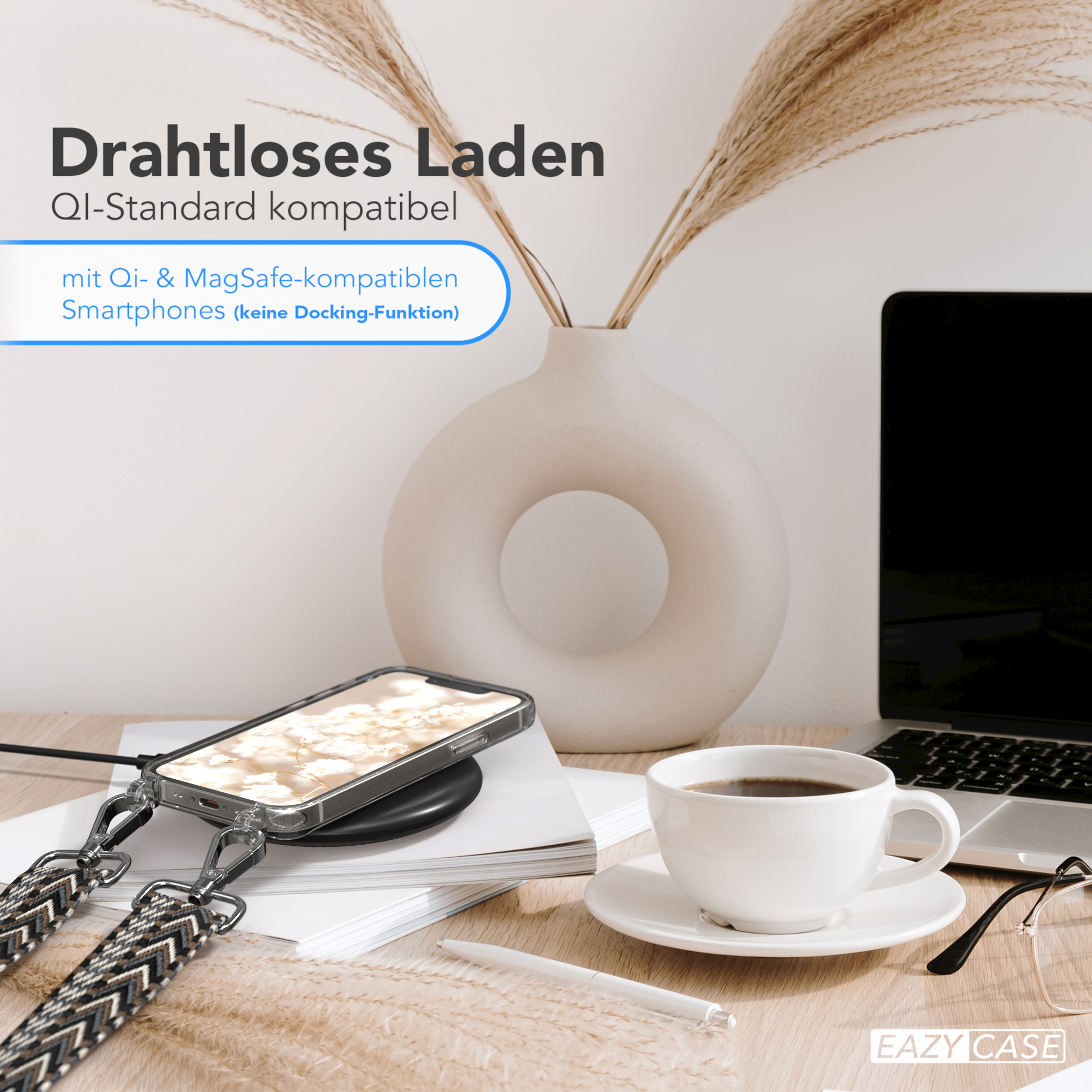 Telefon, das auf einem Schreibtisch aufgeladen wird. Weiße Tasse, Laptop und Vase sind im Hintergrund. Das Handy hat einen Gurt.