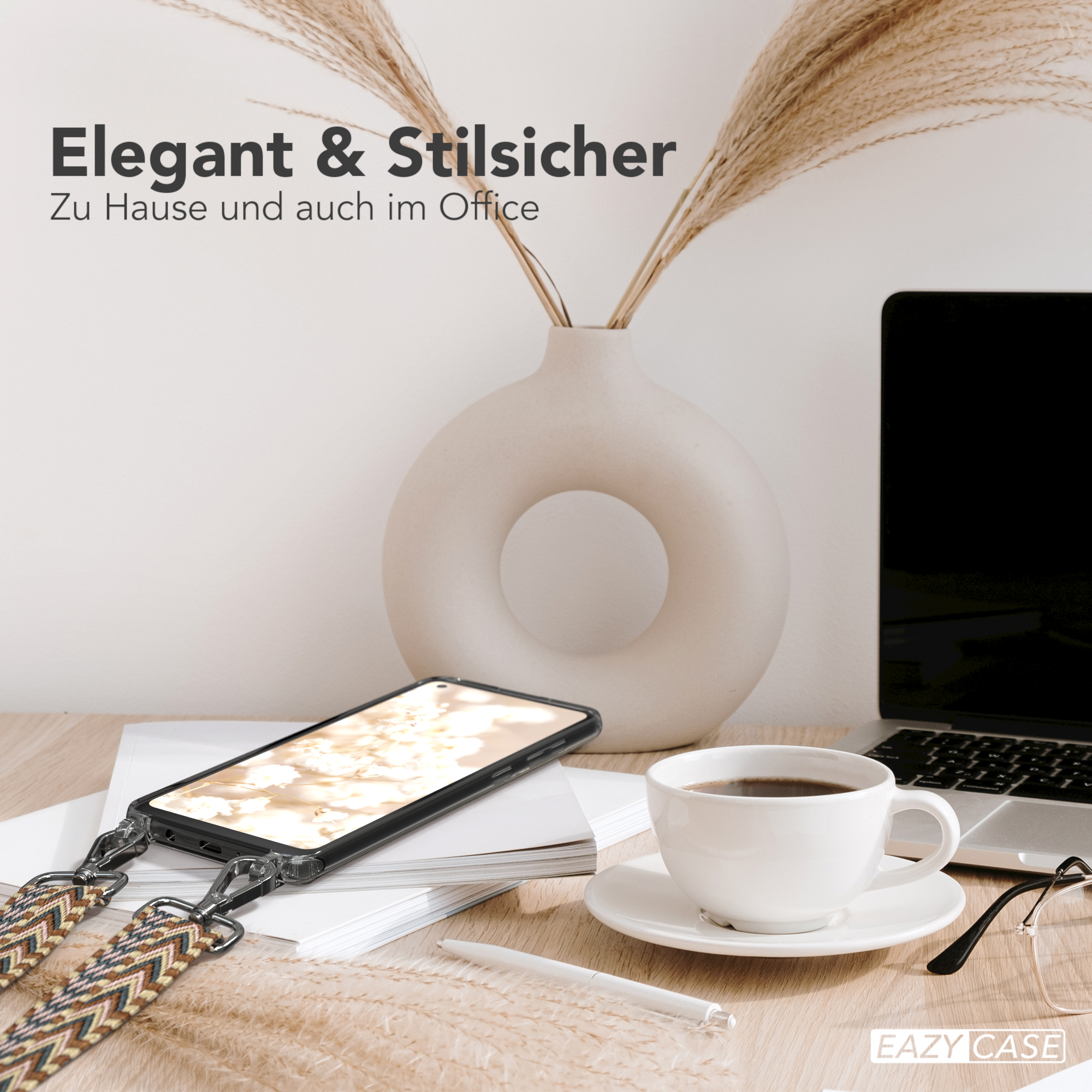 Telefon wird drahtlos auf dem Schreibtisch geladen mit Kaffee, Vase und Laptop. Text: Elegant & stilvoll.