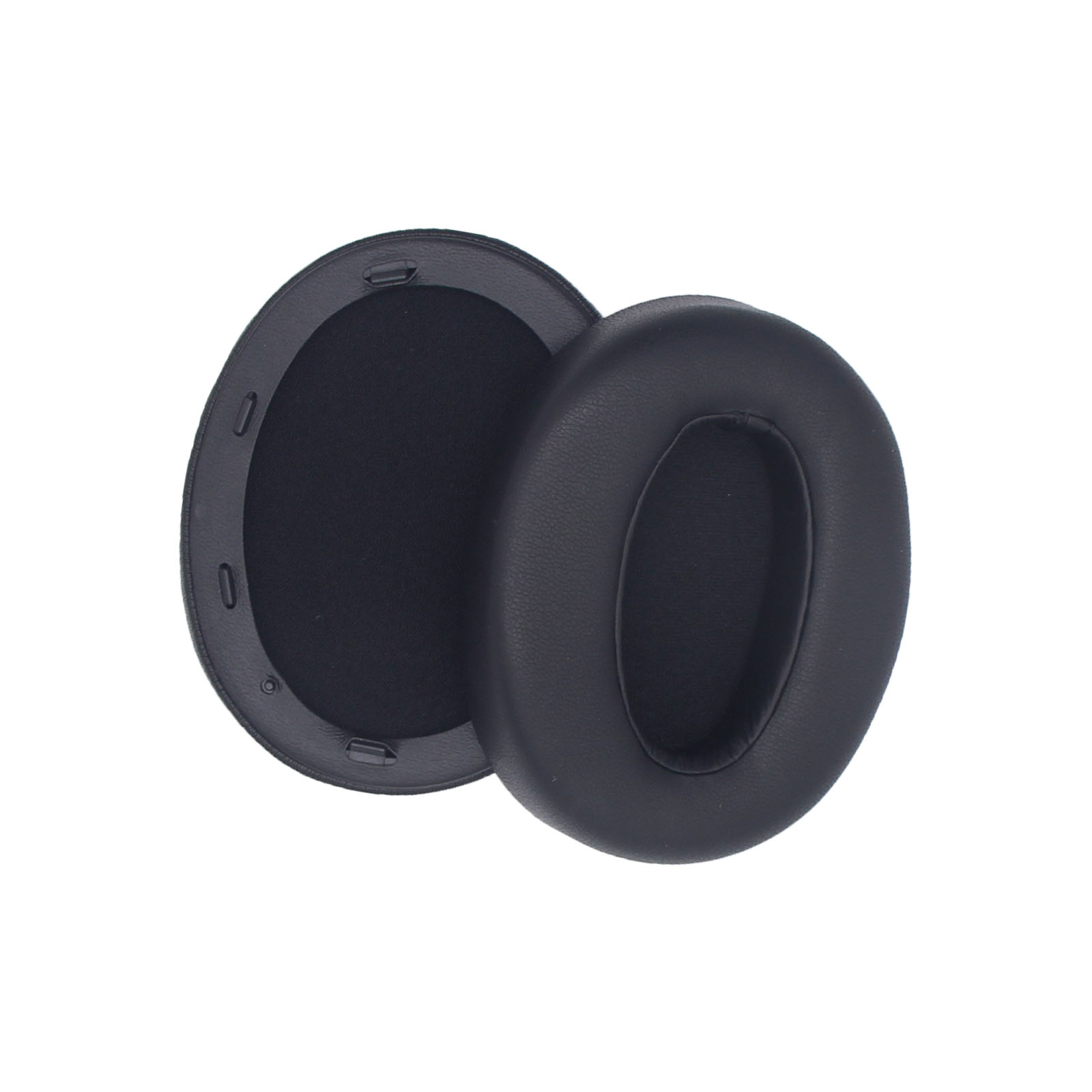 Dwie czarne poduszki na uszy, jedna w drugiej, na białym tle.