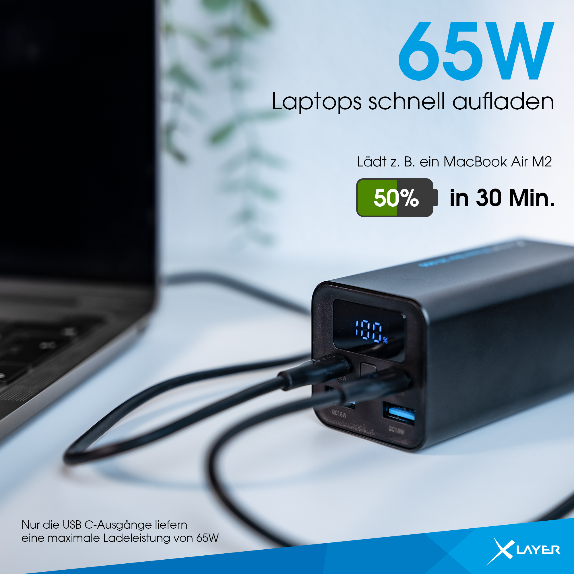 Schwarze Powerbank lädt Laptop. Zeigt 100% Ladung in 30 Min. Text zeigt 65W Laden.
