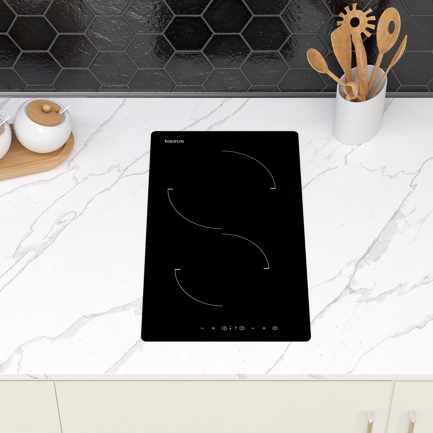 Placa de inducción negra sobre encimera blanca. Marca Taurus visible.