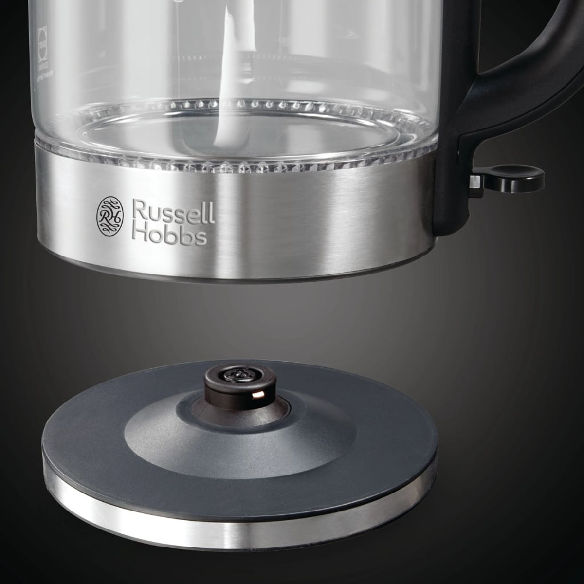 Ein Glaskessel mit silbernem Boden und schwarzem Ständer.