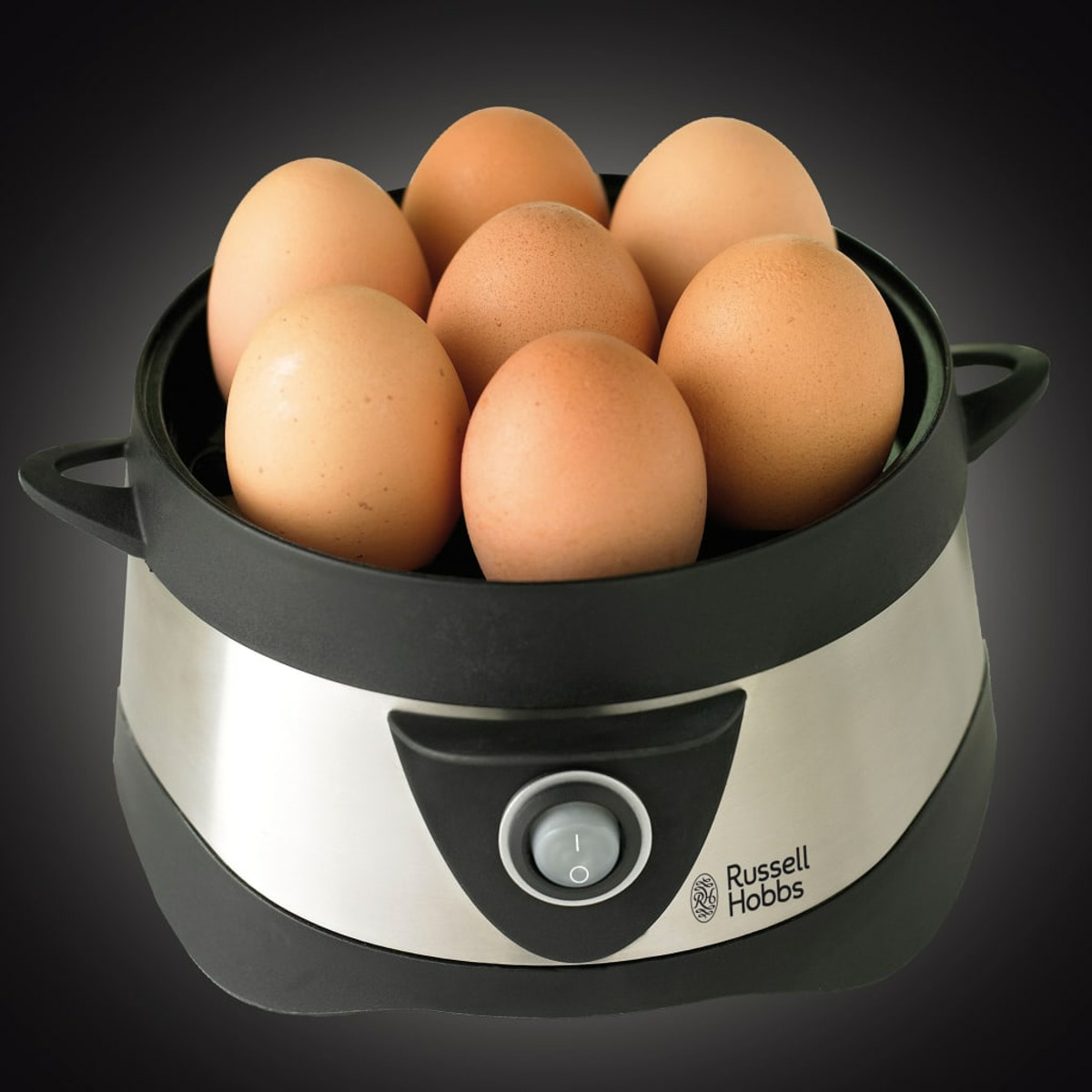 Gotowacz do jajek z siedmioma brązowymi jajkami w środku, stal nierdzewna i czarny design, z przyciskiem zasilania.