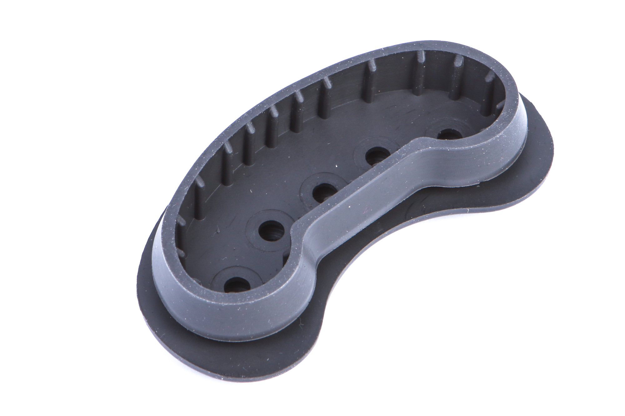 Eine schwarze Gummi-Komponente, oval geformt, mit einer zentralen Aussparung und mehreren kleinen Löchern.