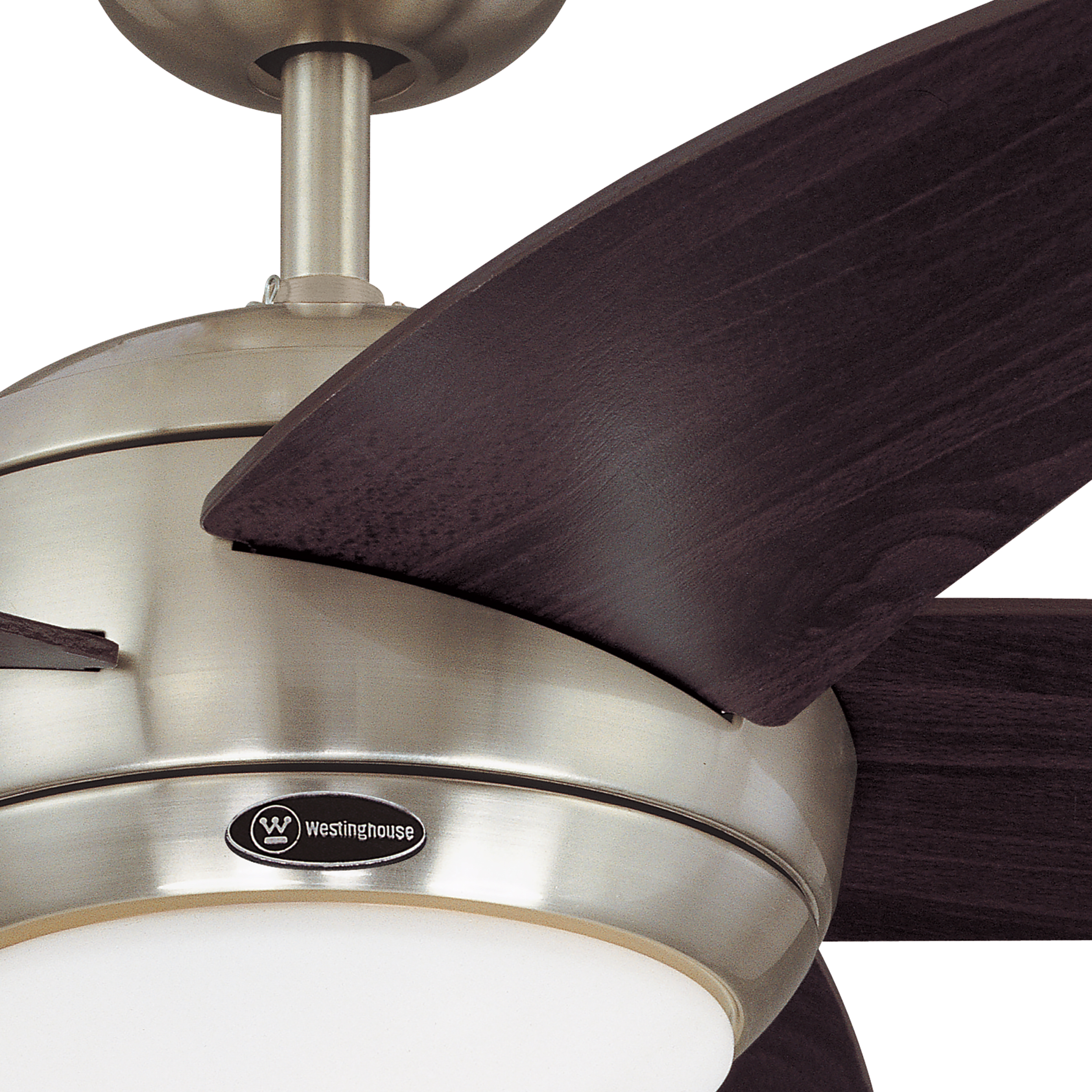 Primo piano di un ventilatore a soffitto. Il ventilatore è argentato con pale marrone scuro e una luce.