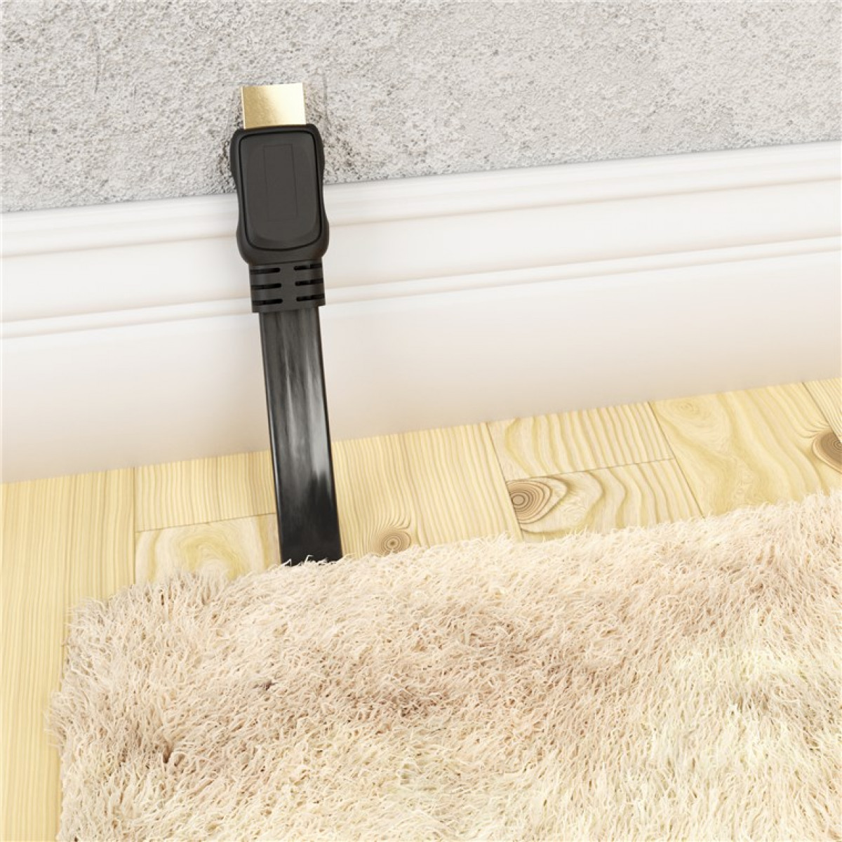 Ein schwarzes Kabel, das eine Wand hinunterläuft und teilweise von einem Teppich verdeckt wird.