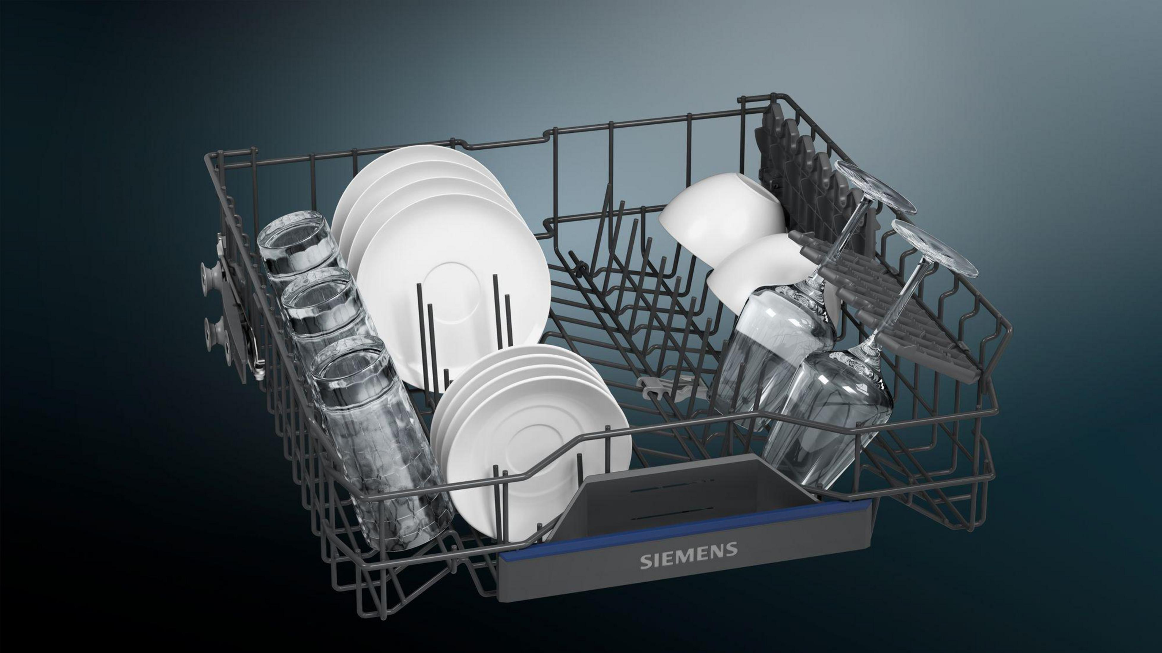 Dishwasher basket with plates, glasses, and cups, against a dark blue background.