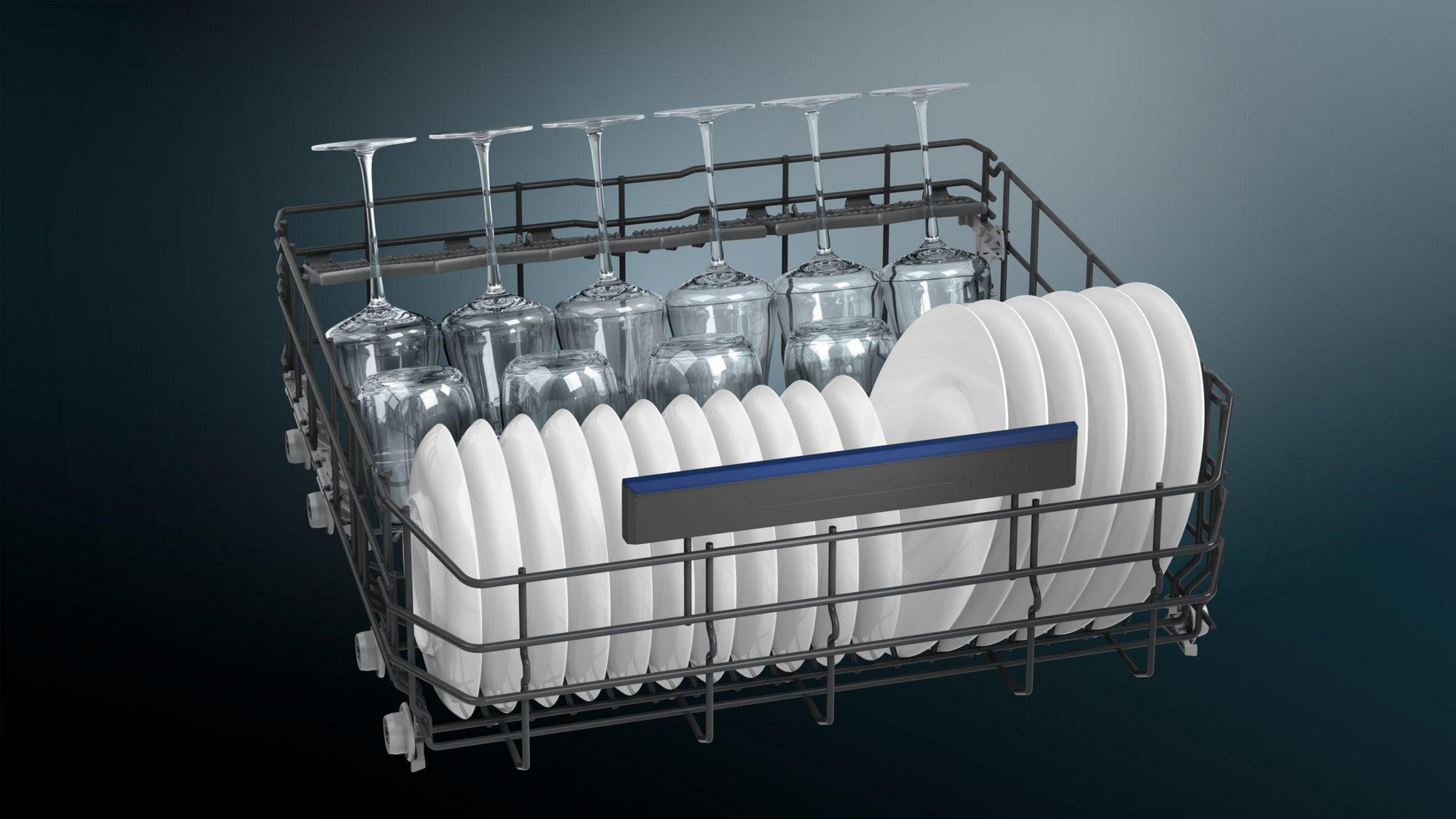 Dishwasher interior with glasses and plates. The image shows a full dishwasher rack.