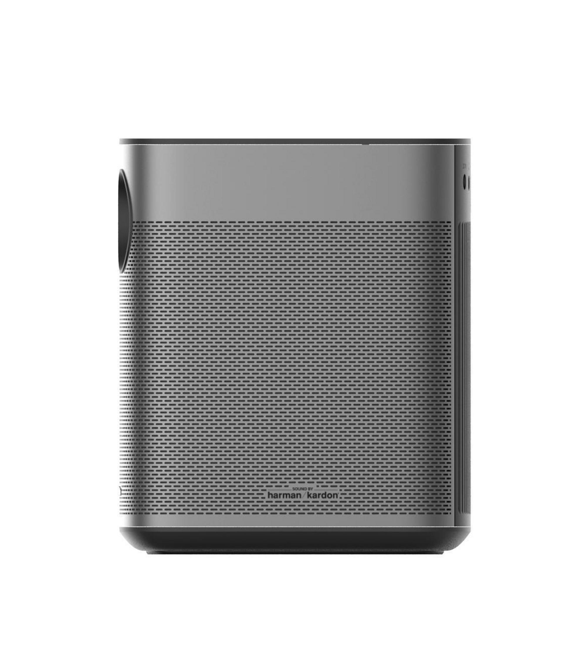 Grey projector with a speaker. Harman Kardon is written on it. White background.