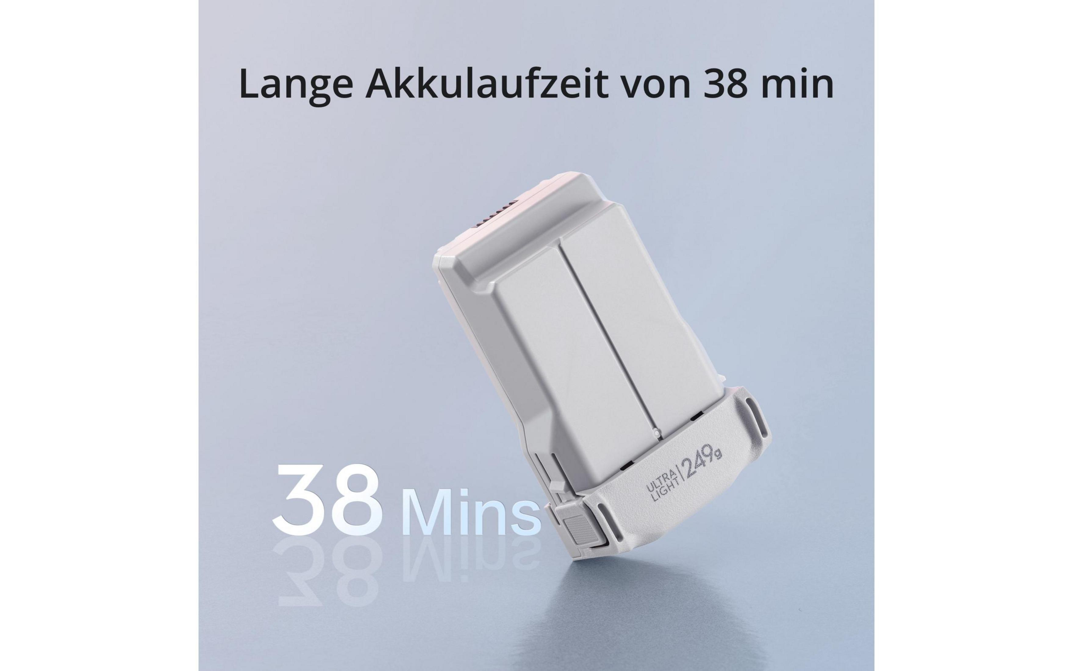 Biały akumulator do drona z tekstem. Tekst brzmi: 'Długi czas pracy baterii 38 min'.
