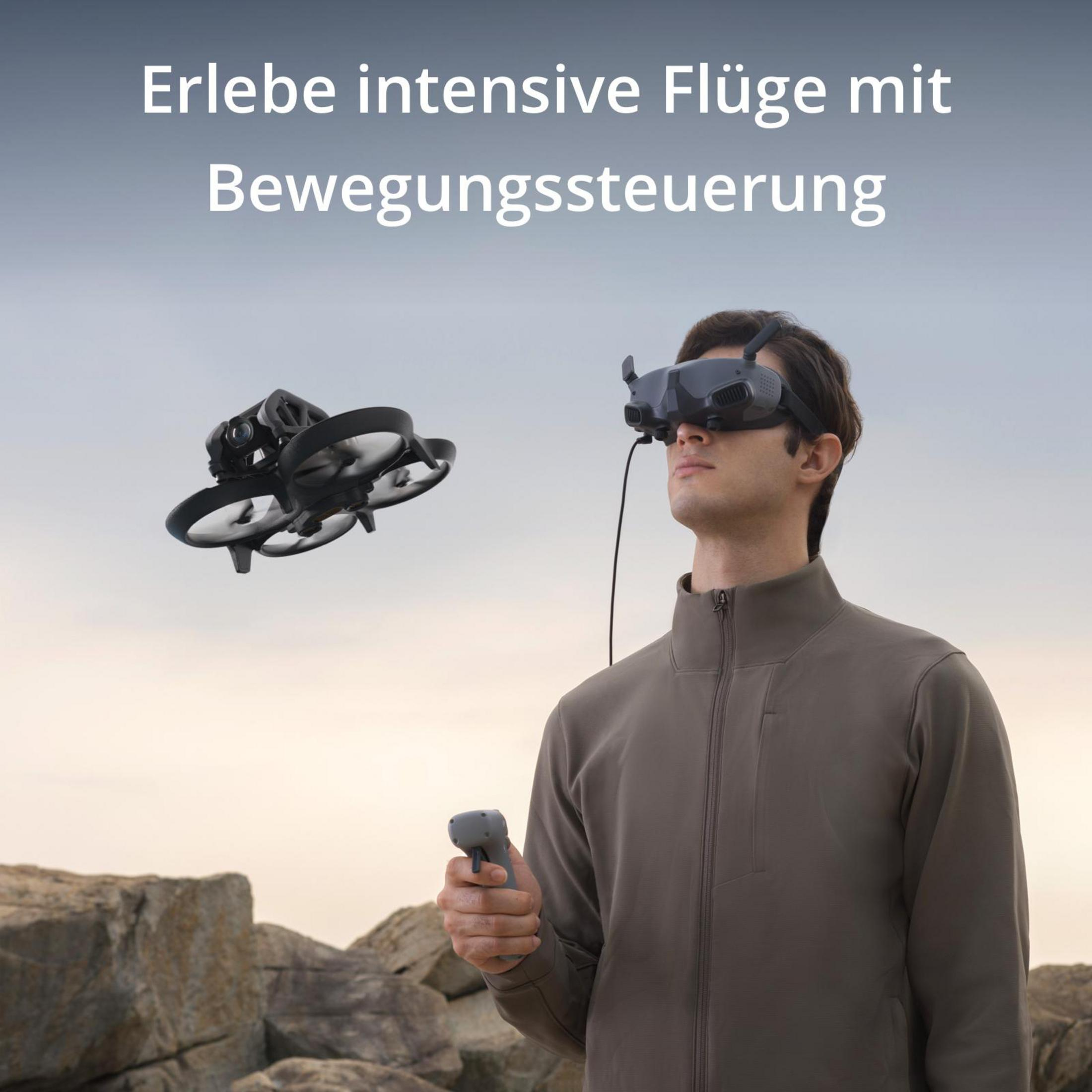 Un hombre con gafas de realidad virtual y un controlador, con un dron volando detrás.