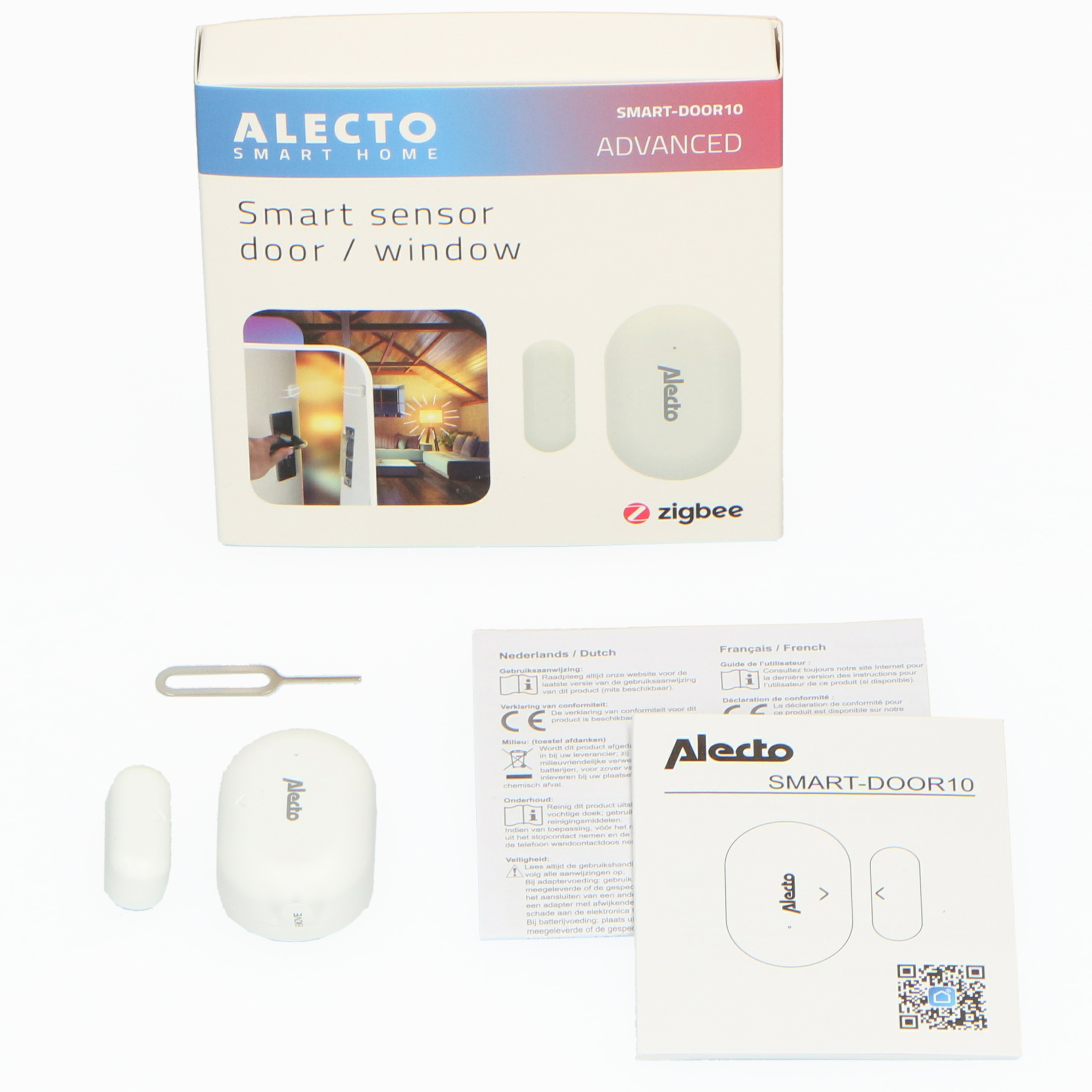 Eine weiße Alecto Smart Tür/Fenster Sensorbox und Komponenten. Enthält einen Sensor, einen Magneten und Anweisungen.