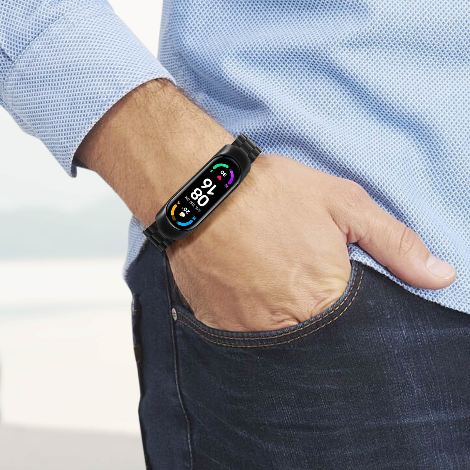 Polso di uomo con smartwatch nero che mostra ora, data e metriche di salute.