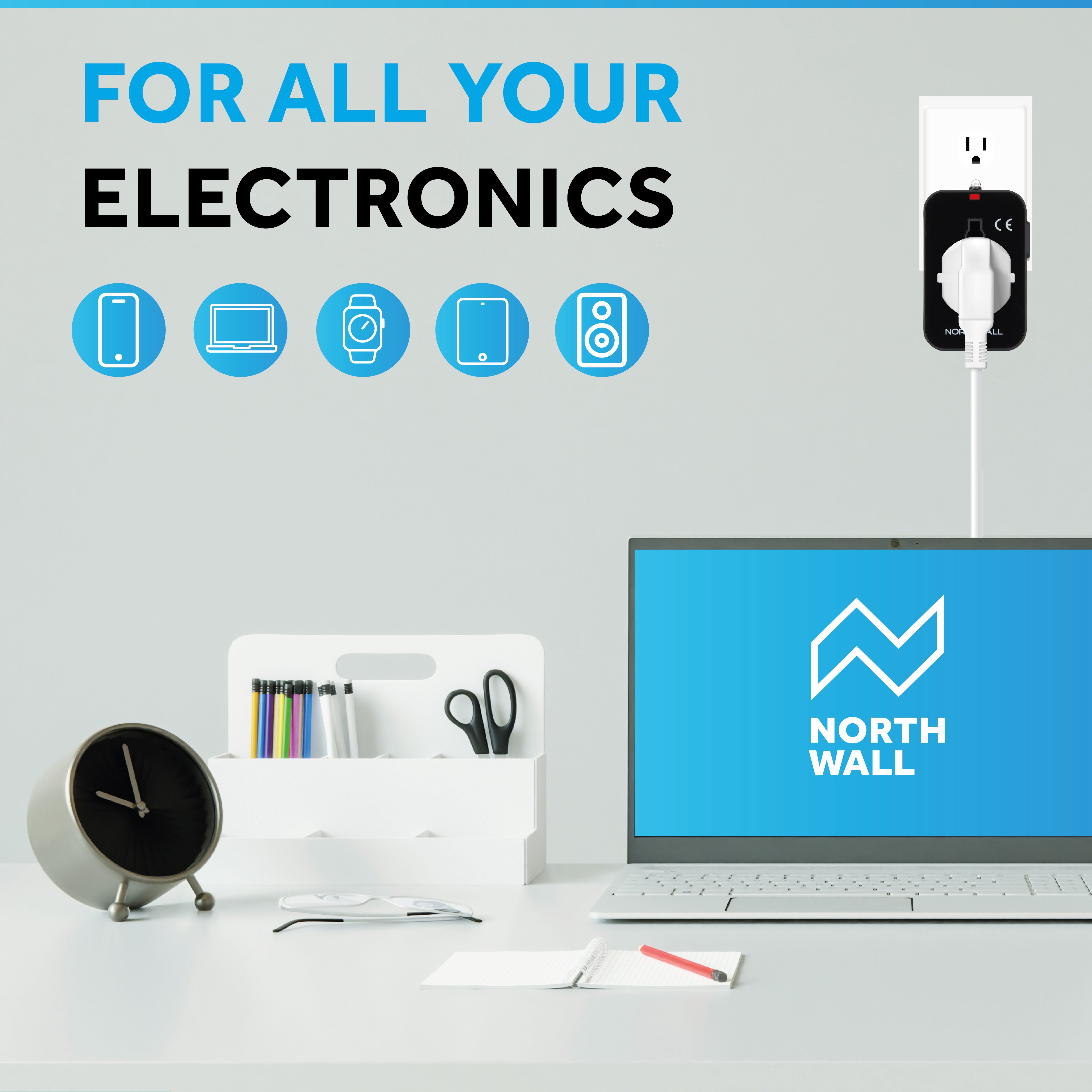 A desk with laptop, accessories, and electronics, and a North Wall logo.