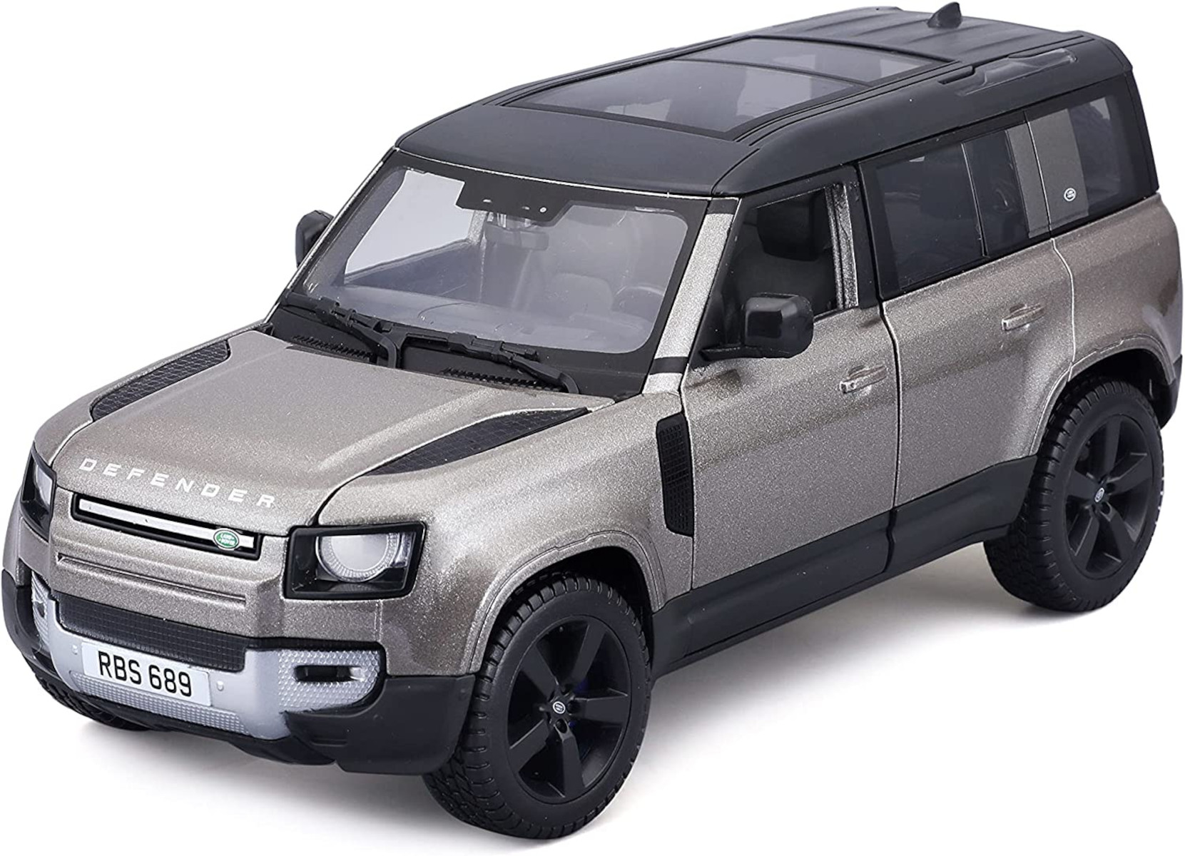 Silbernes Modellauto eines Land Rover Defender SUV mit schwarzem Dach und Reifen.