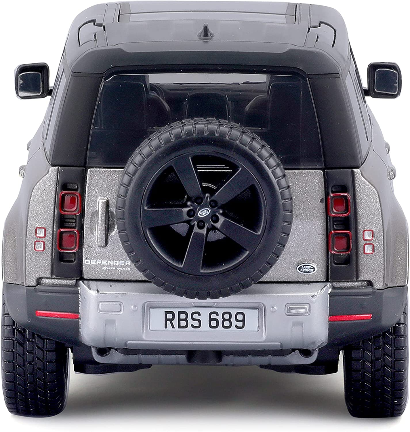 Rückansicht grauer Land Rover Defender Spielzeugauto, schwarzes Reserverad, weißes Kennzeichen.