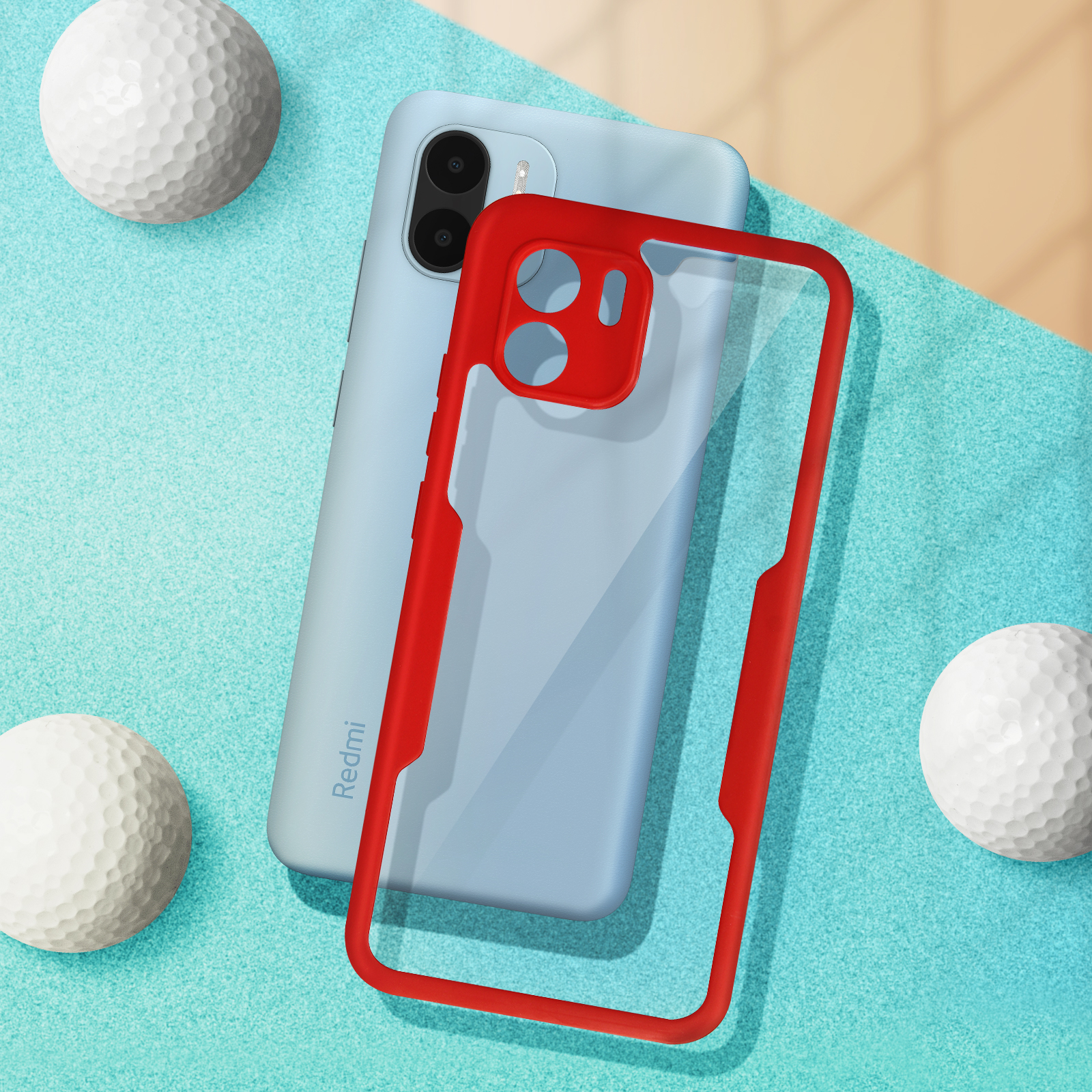 Un telefono blu con una custodia rossa e due palline da golf su una superficie blu.